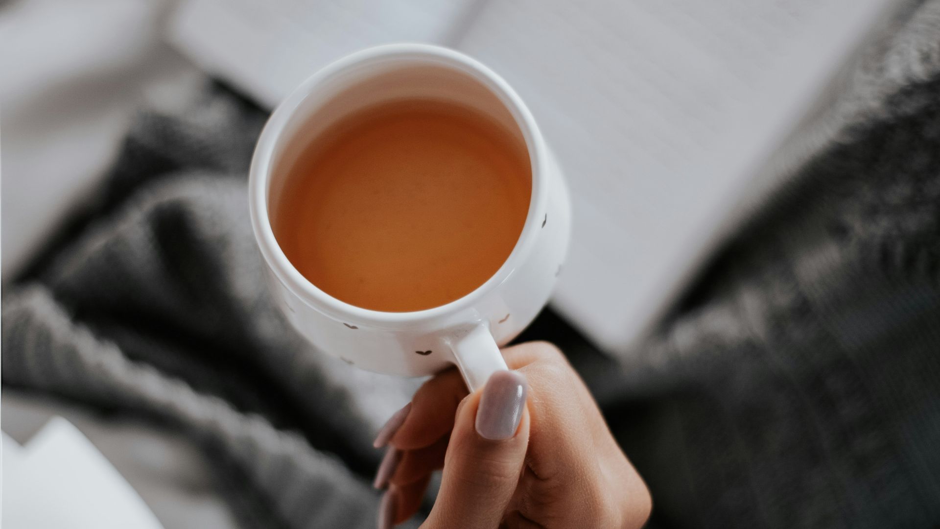 person holding white ceramic mug