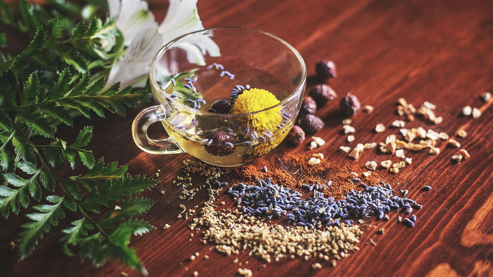 clear tea cup on brown surface