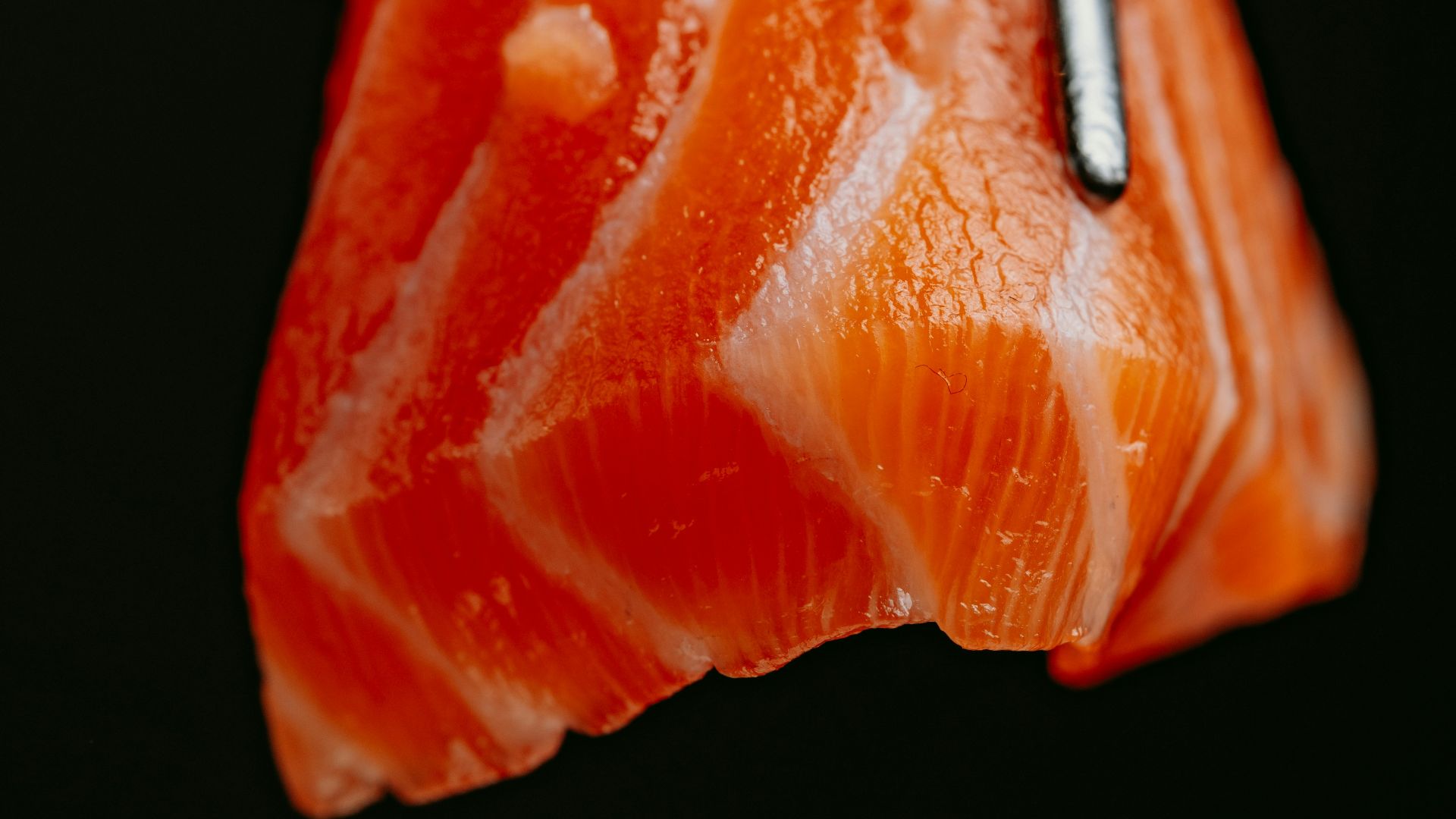 a piece of sushi with chopsticks sticking out of it