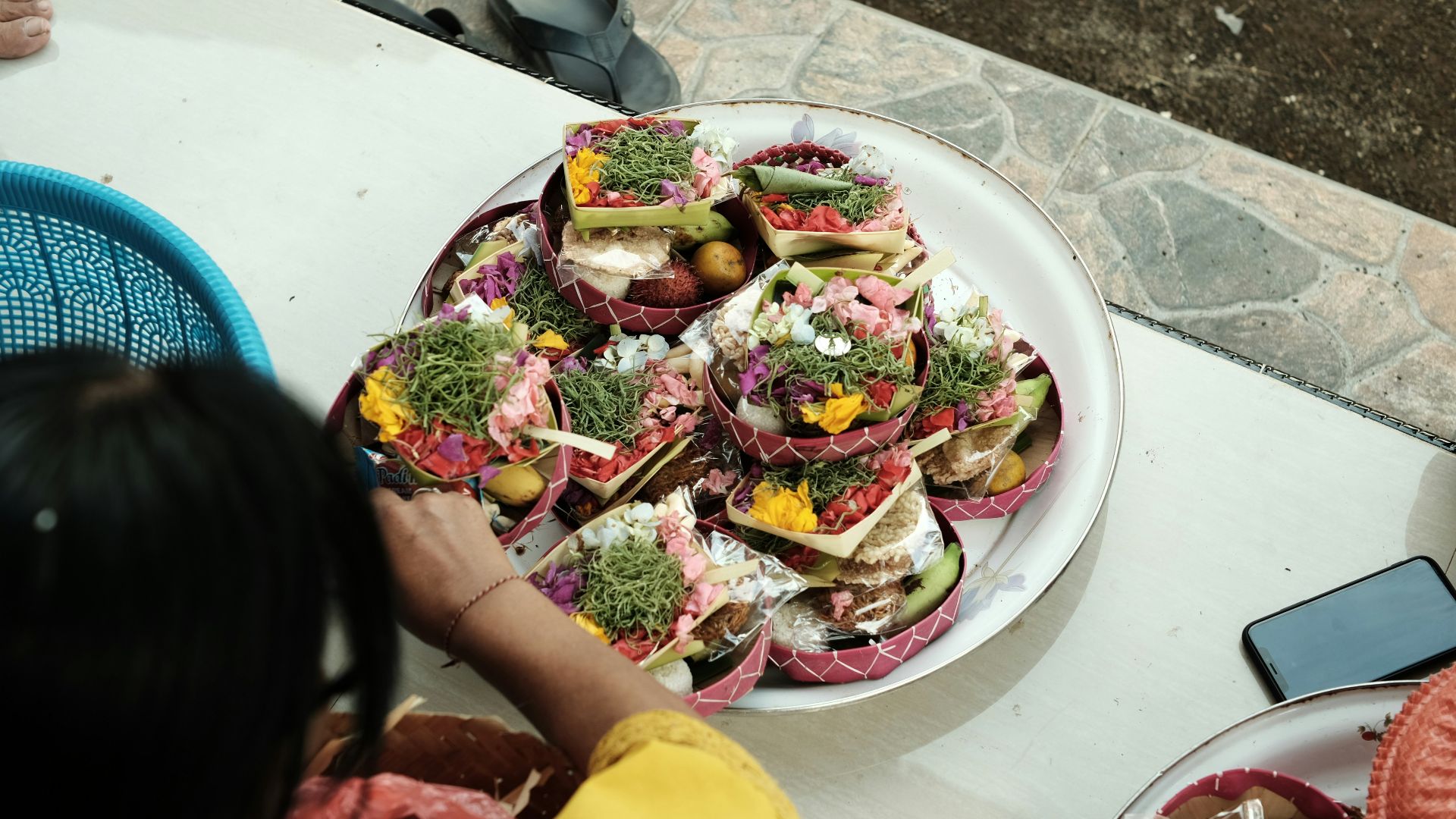 a plate of food on a table with a person looking at it