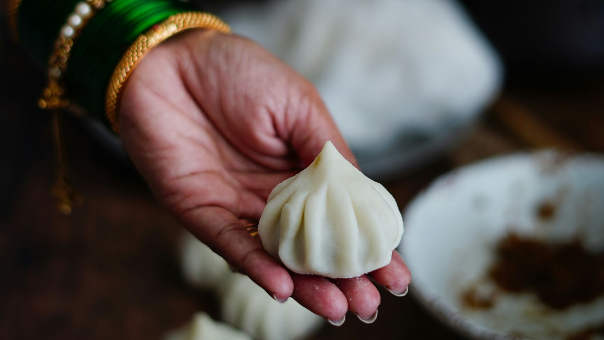 person holding white garlic bulb