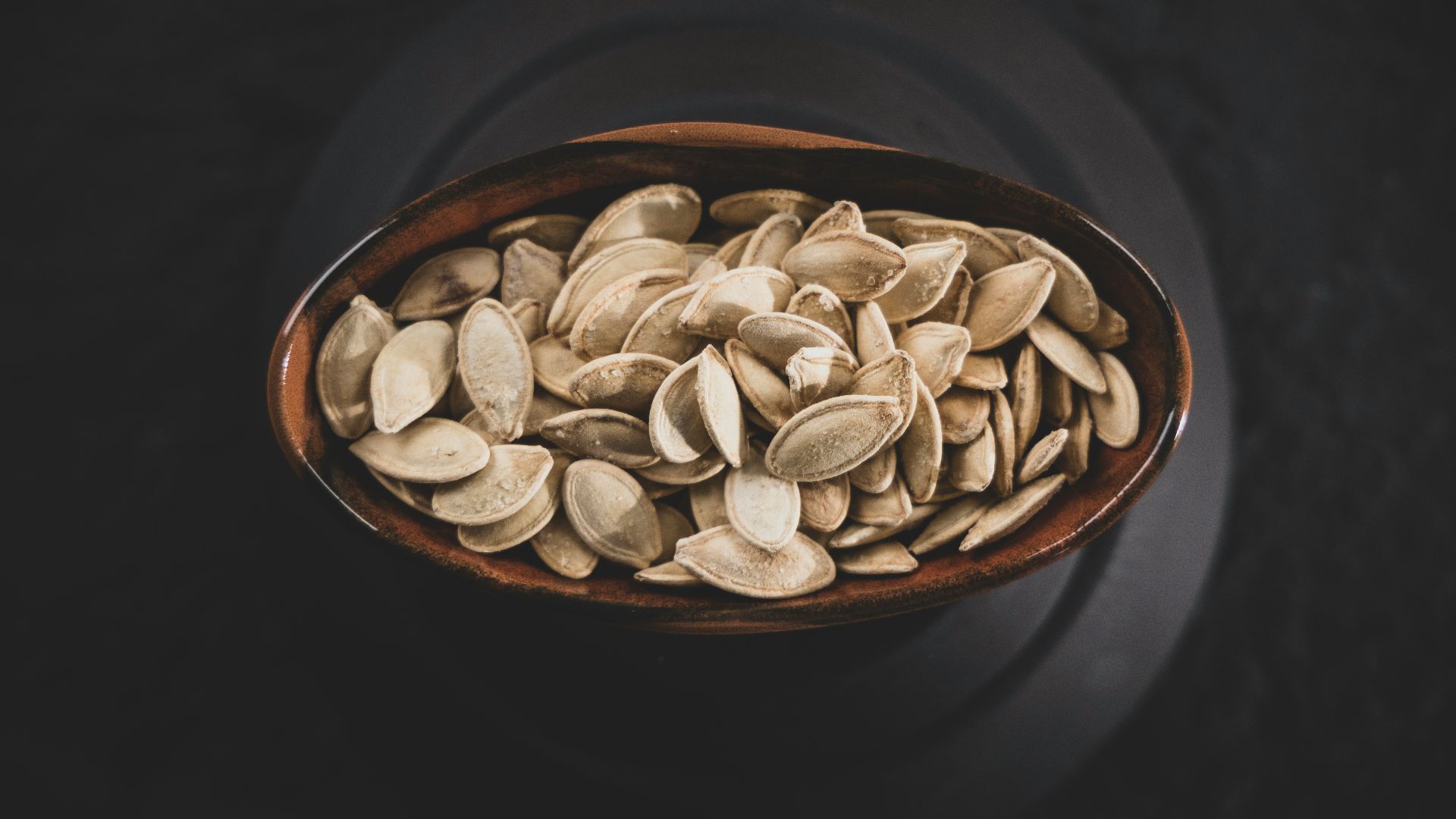 brown and white nuts on brown ceramic bowl