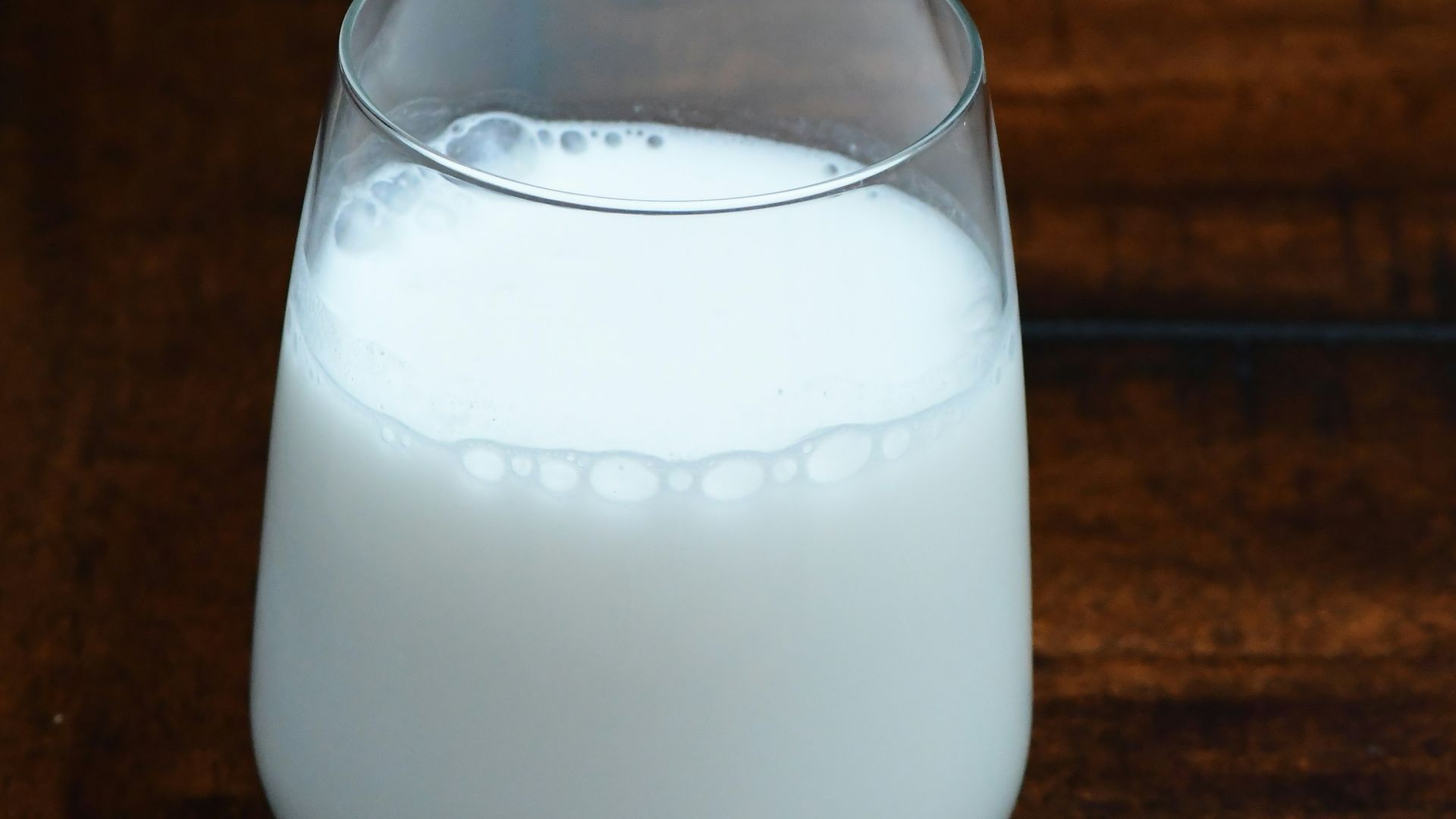 clear drinking glass with white liquid