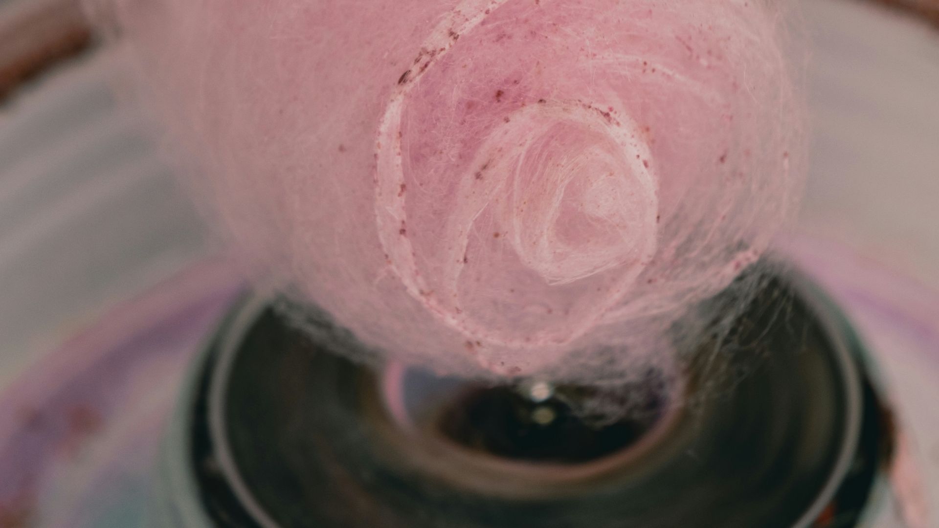 a pink ball of yarn is in a bowl