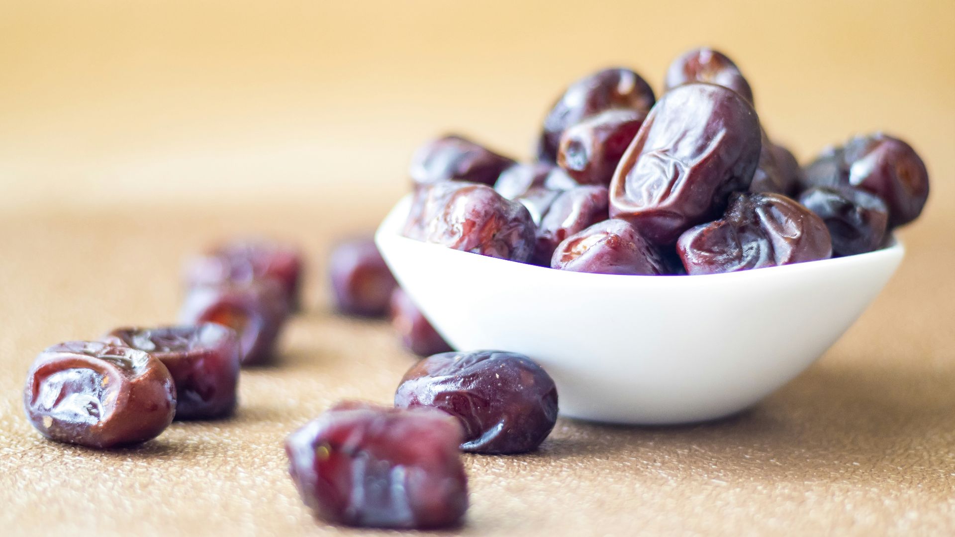 brown round fruit on white ceramic bowl