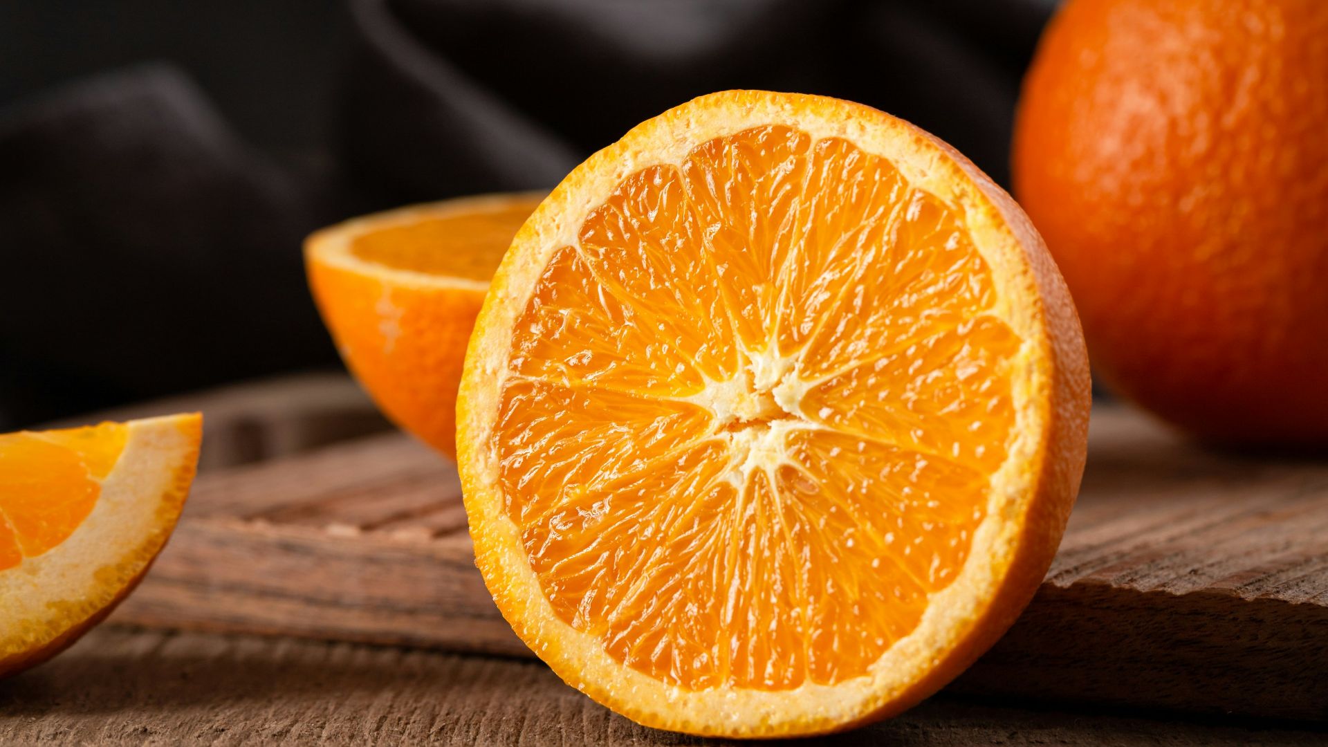 sliced orange fruit on brown wooden table