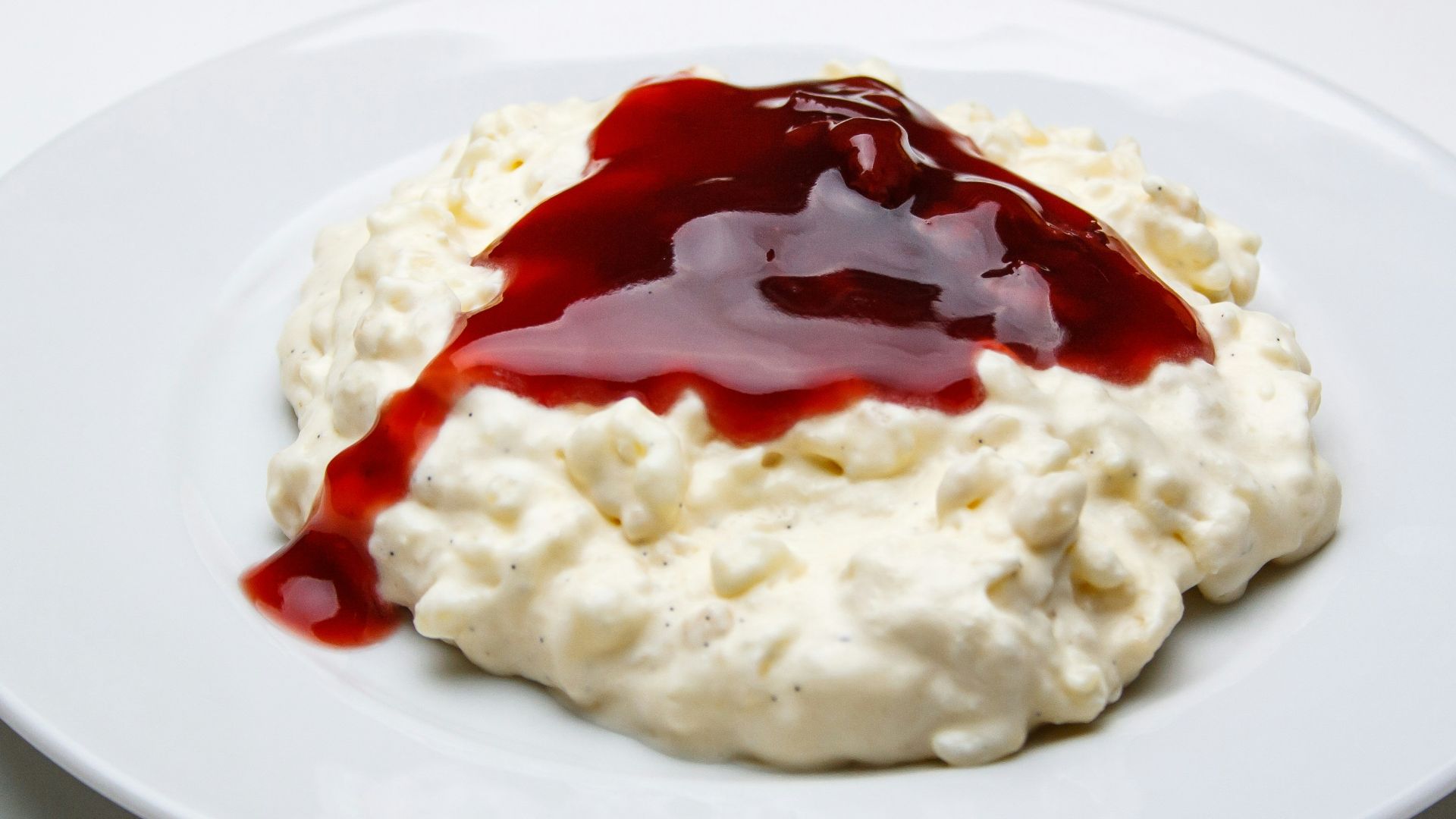 white rice with red sauce on white ceramic plate