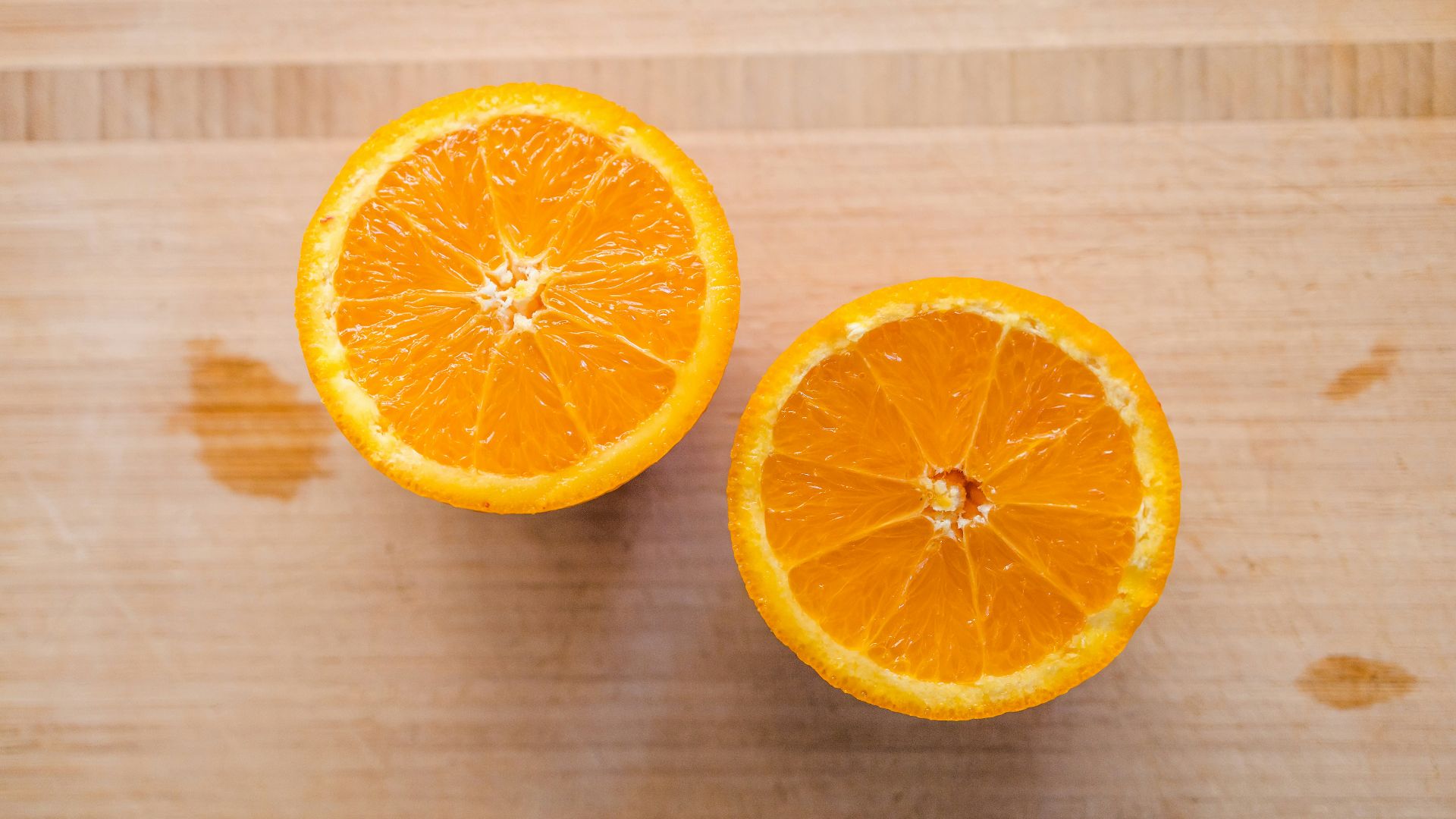 sliced orange fruit on brown wooden table