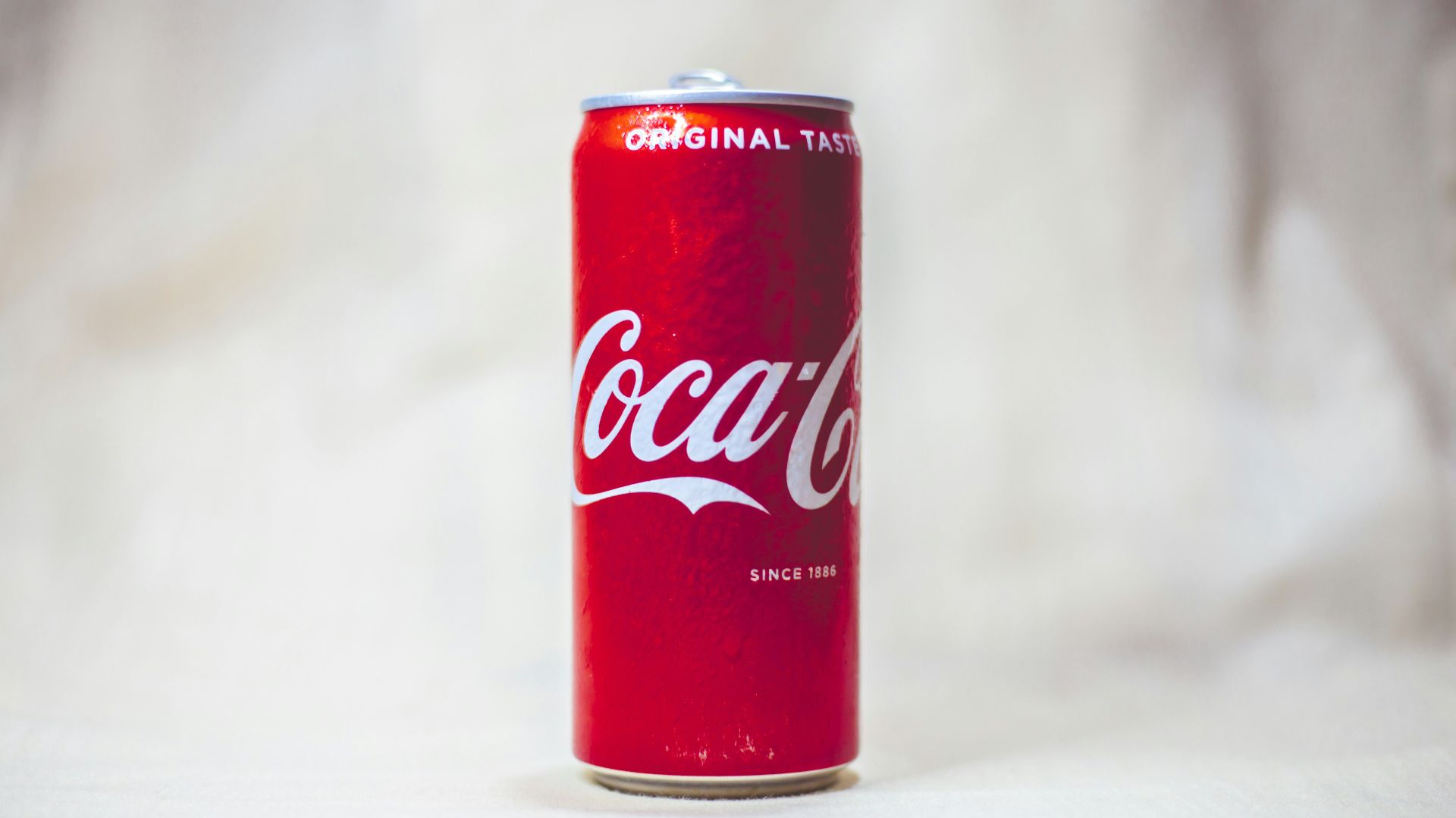 coca cola can on white table