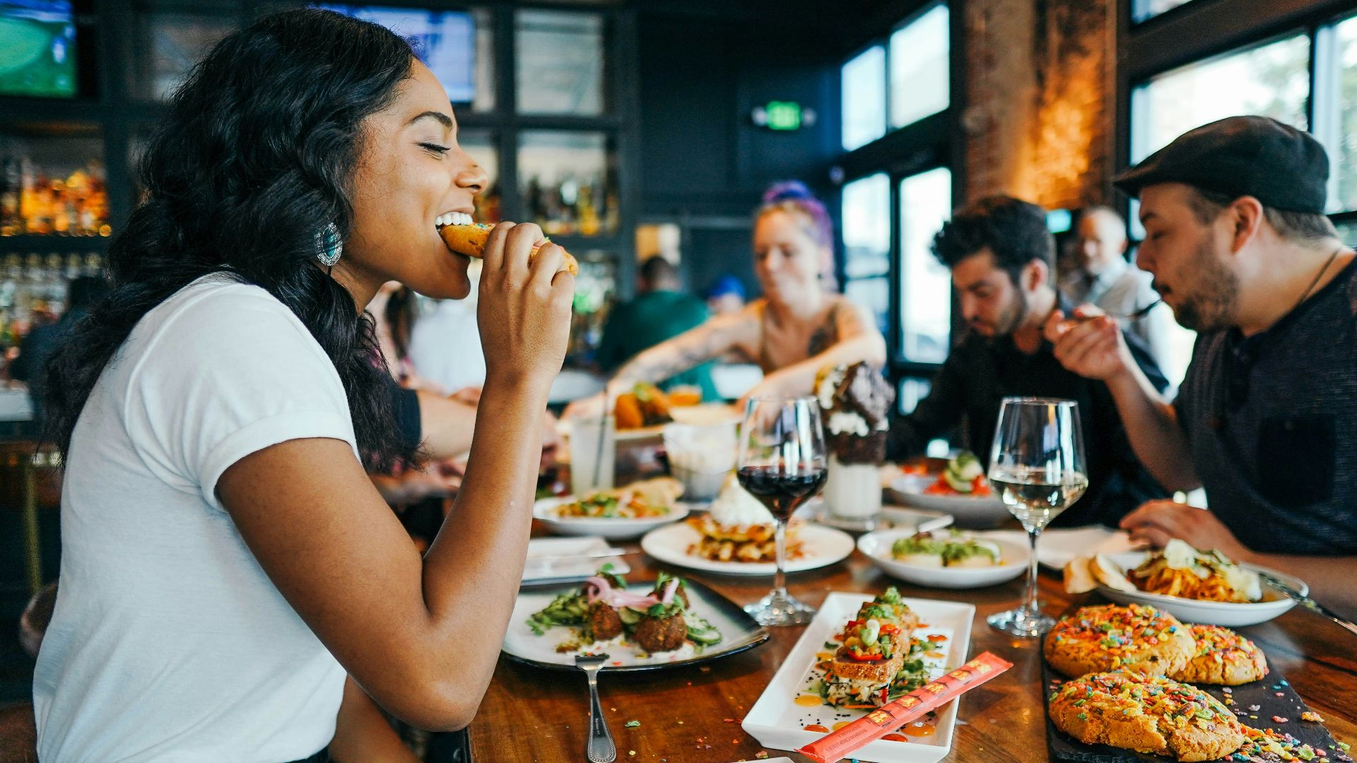 woman in white shirt eating