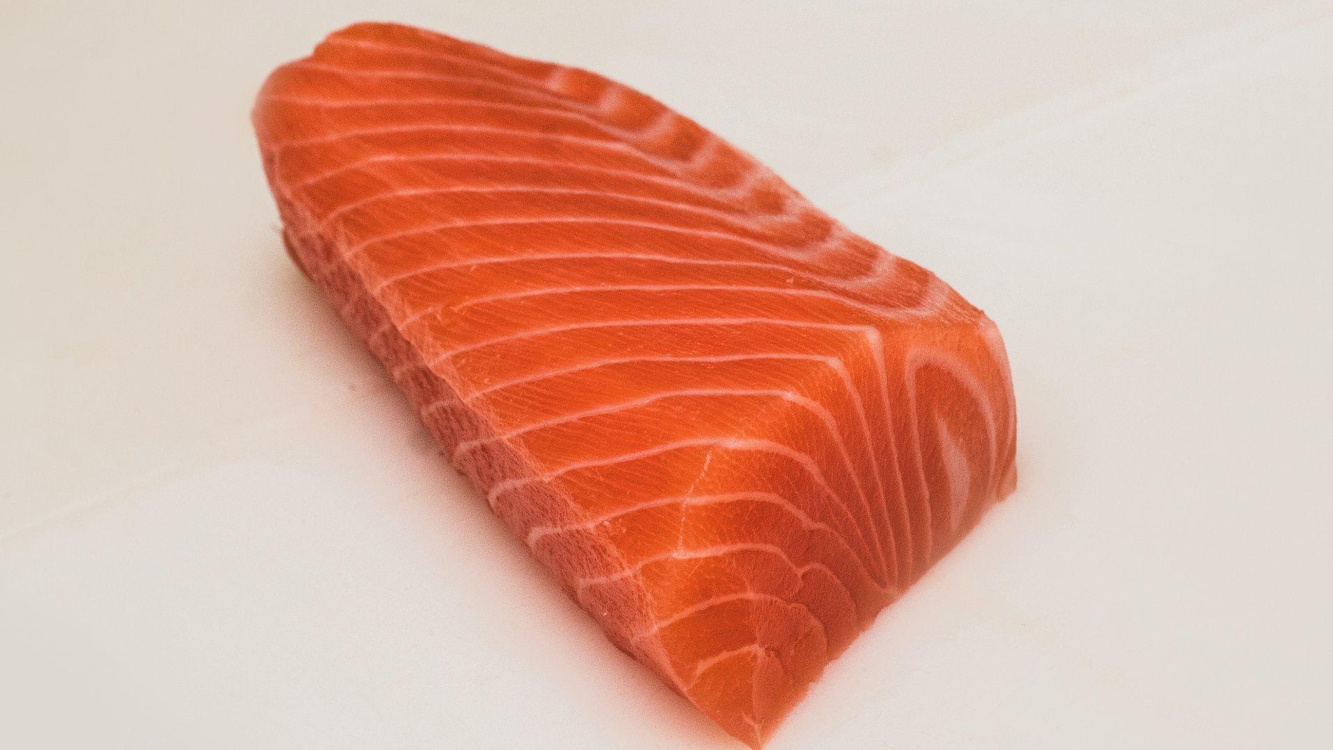 sliced fish meat on white surface