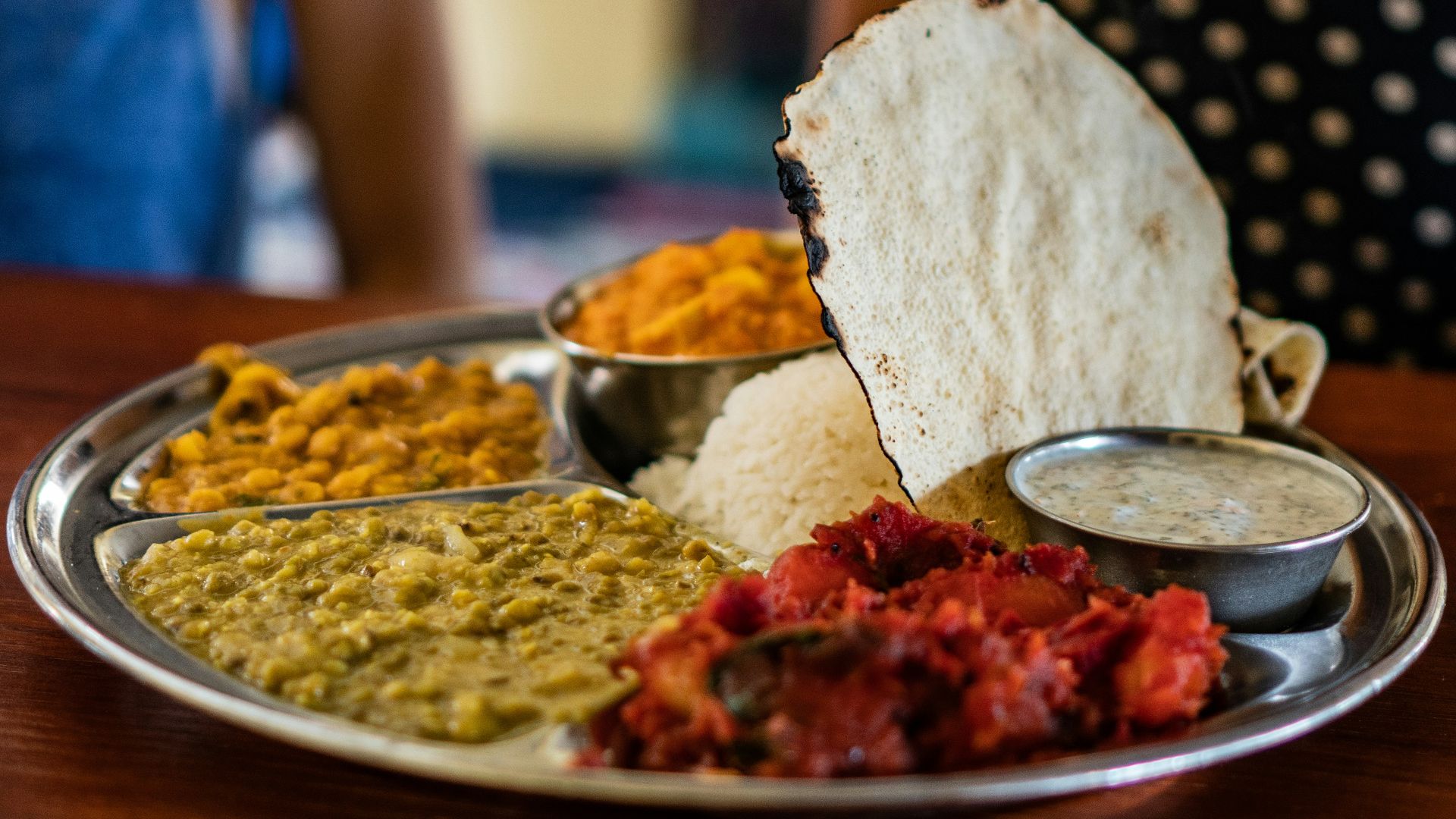 flatbread beside steam rice and stew meat platter