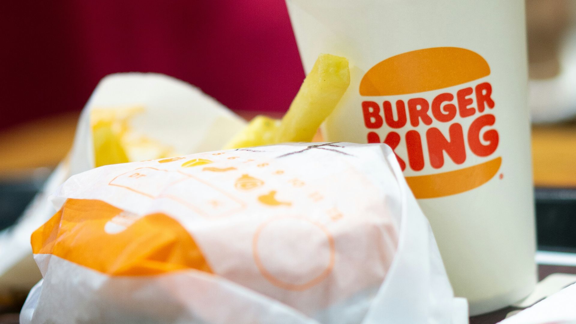 a burger king sandwich and a cup of coffee