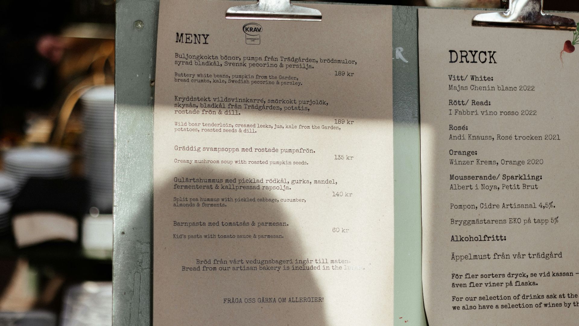 A menu sitting on top of a table next to a cup of coffee