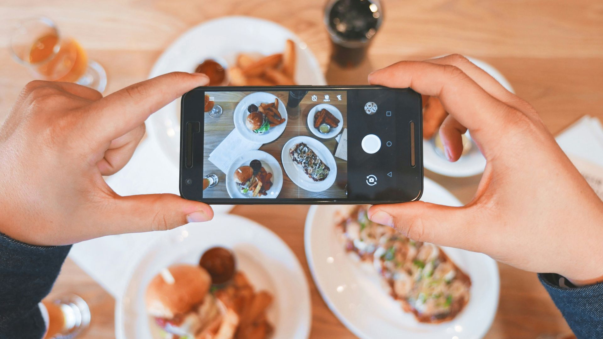 person taking picture of the foods
