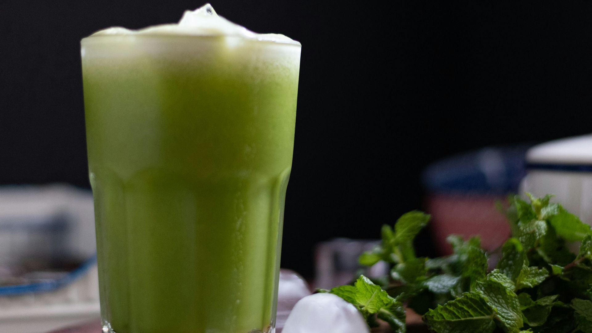 green liquid in clear drinking glass