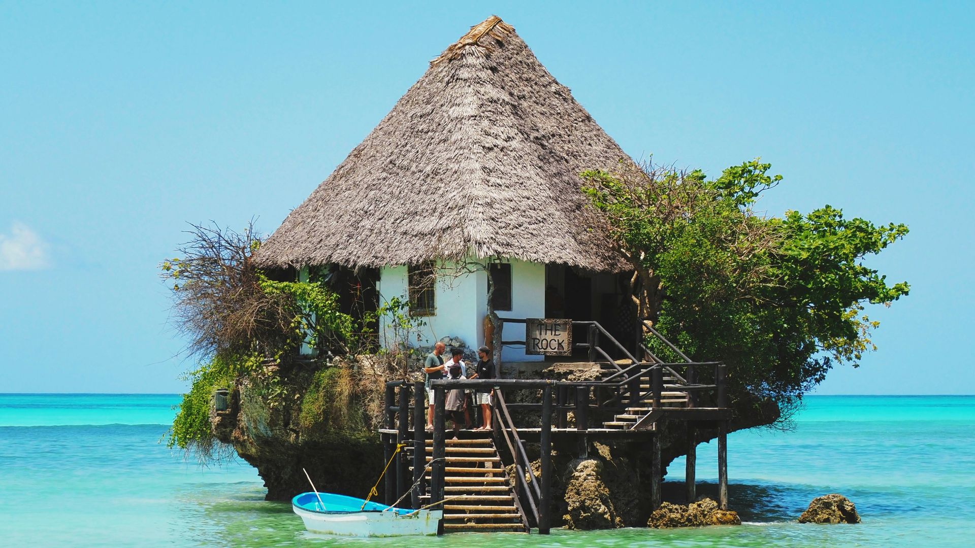 A hut on a small island in the middle of the ocean