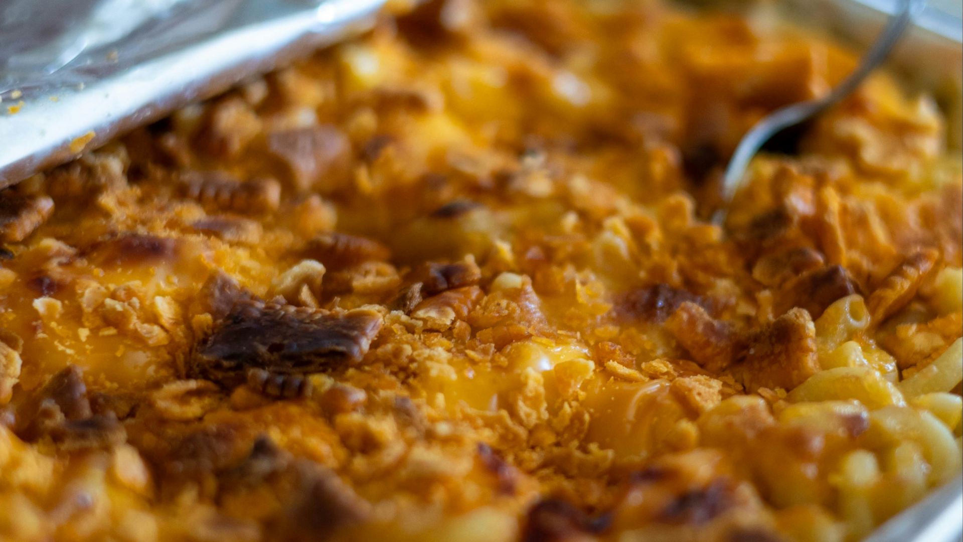 a dish of macaroni and cheese with a spoon in it