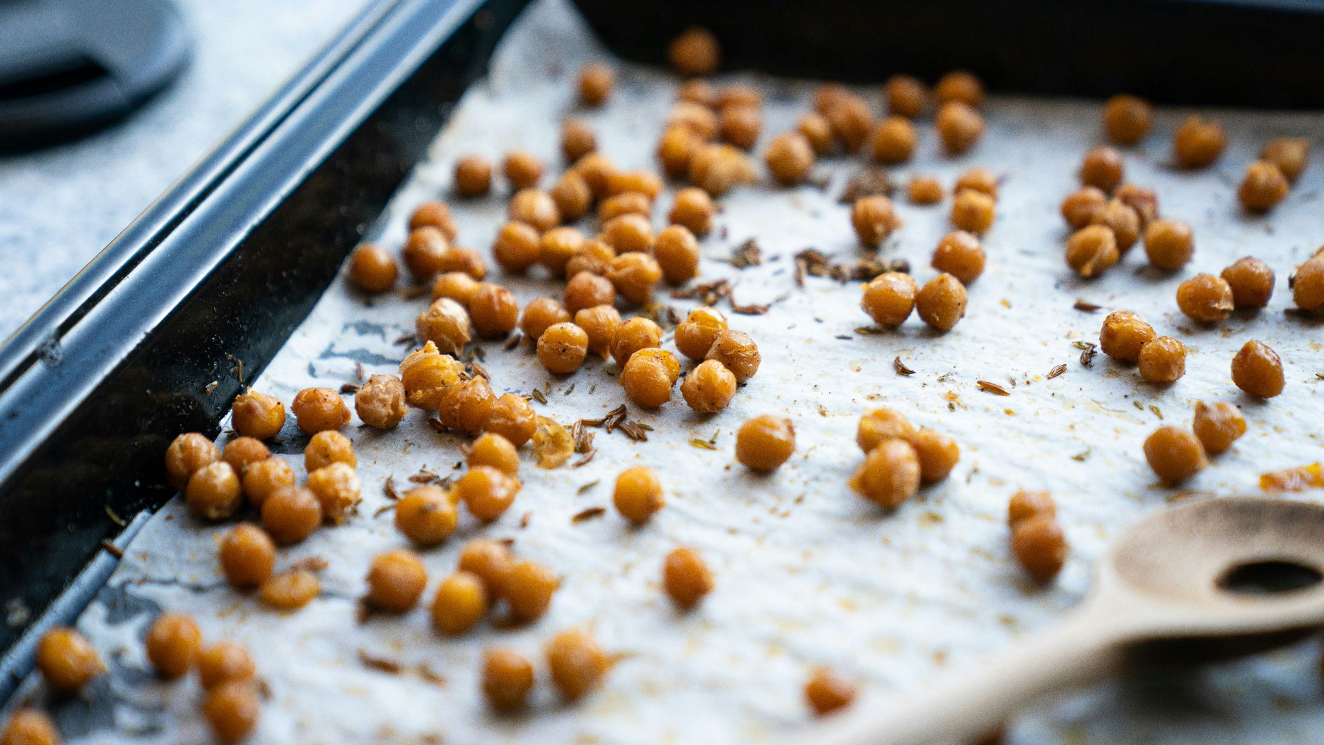 a pan filled with chickpeas and a wooden spoon