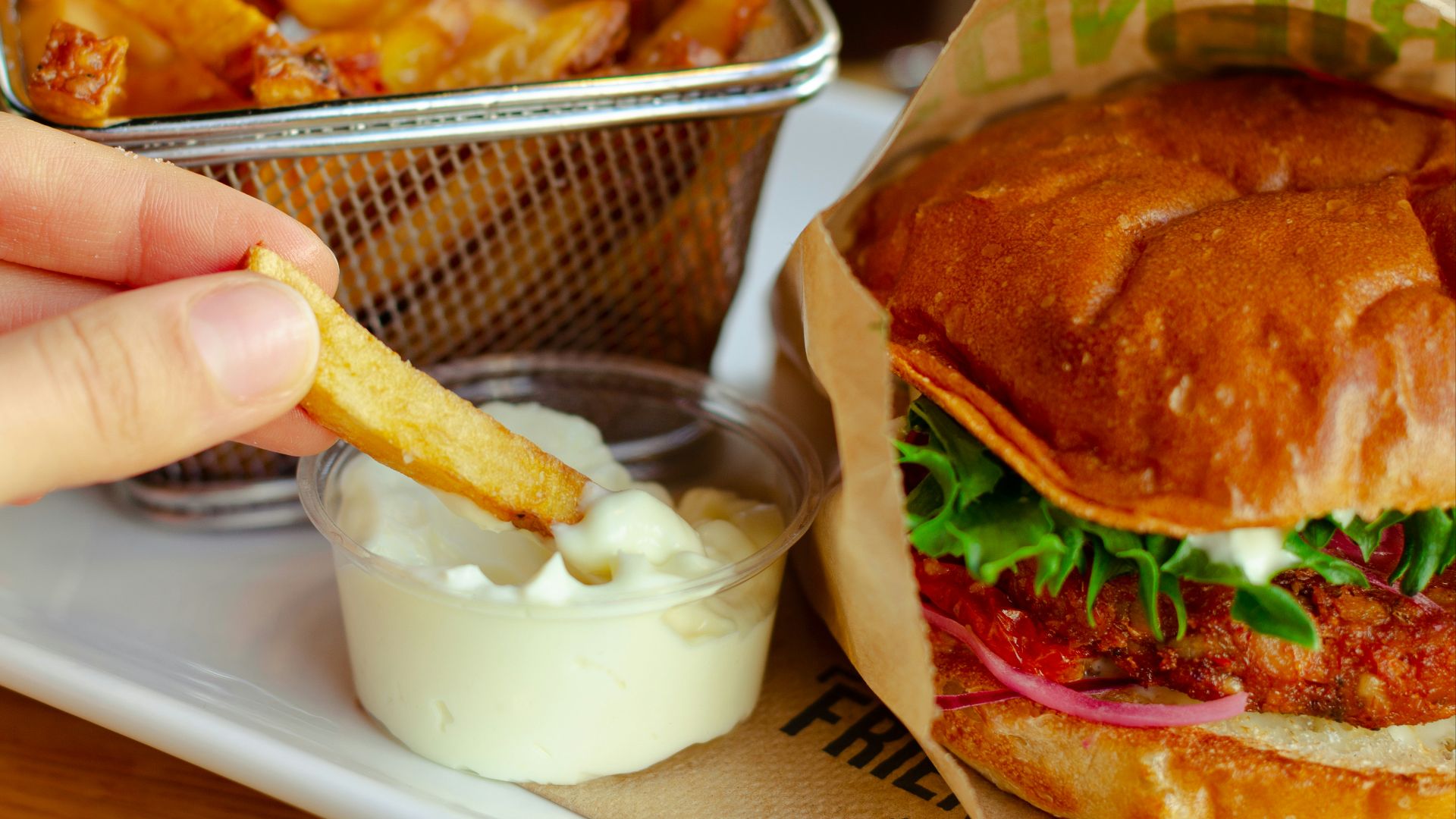 burger with cheese and vegetable on stainless steel tray