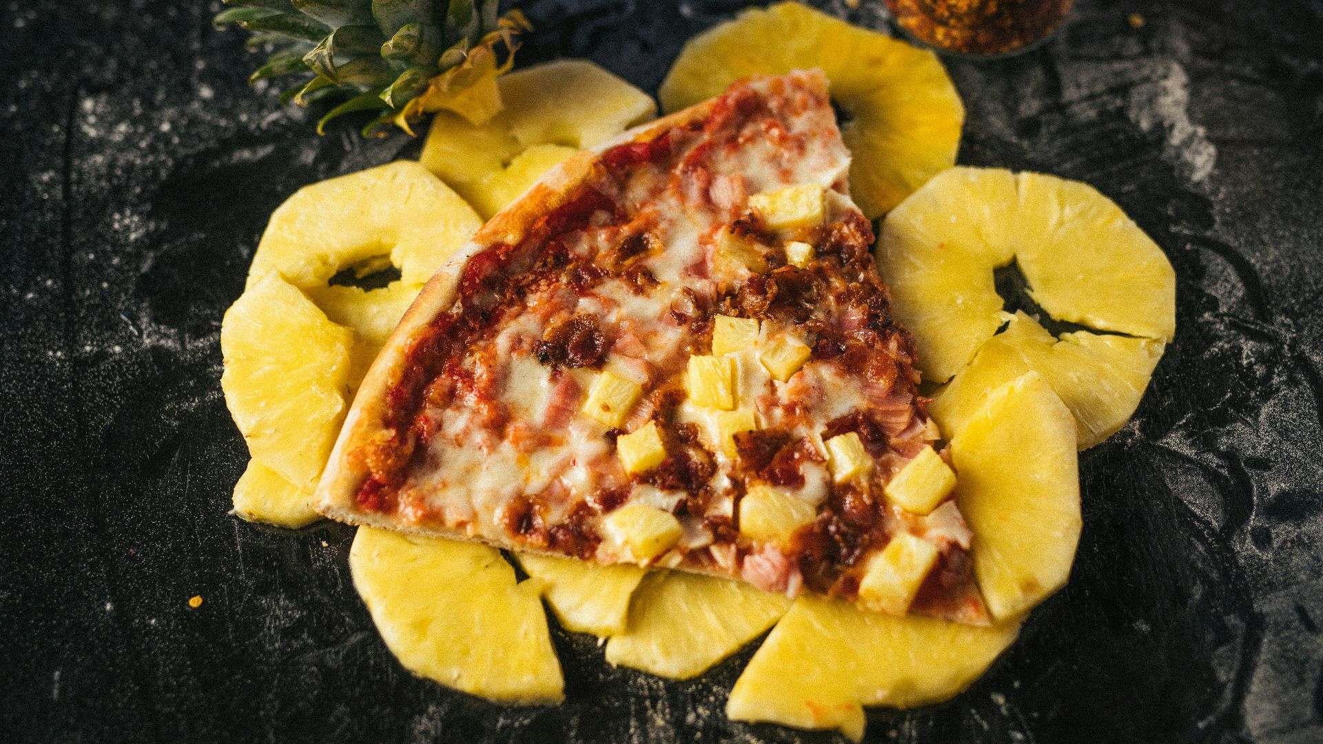 a piece of pizza with pineapple on top of it