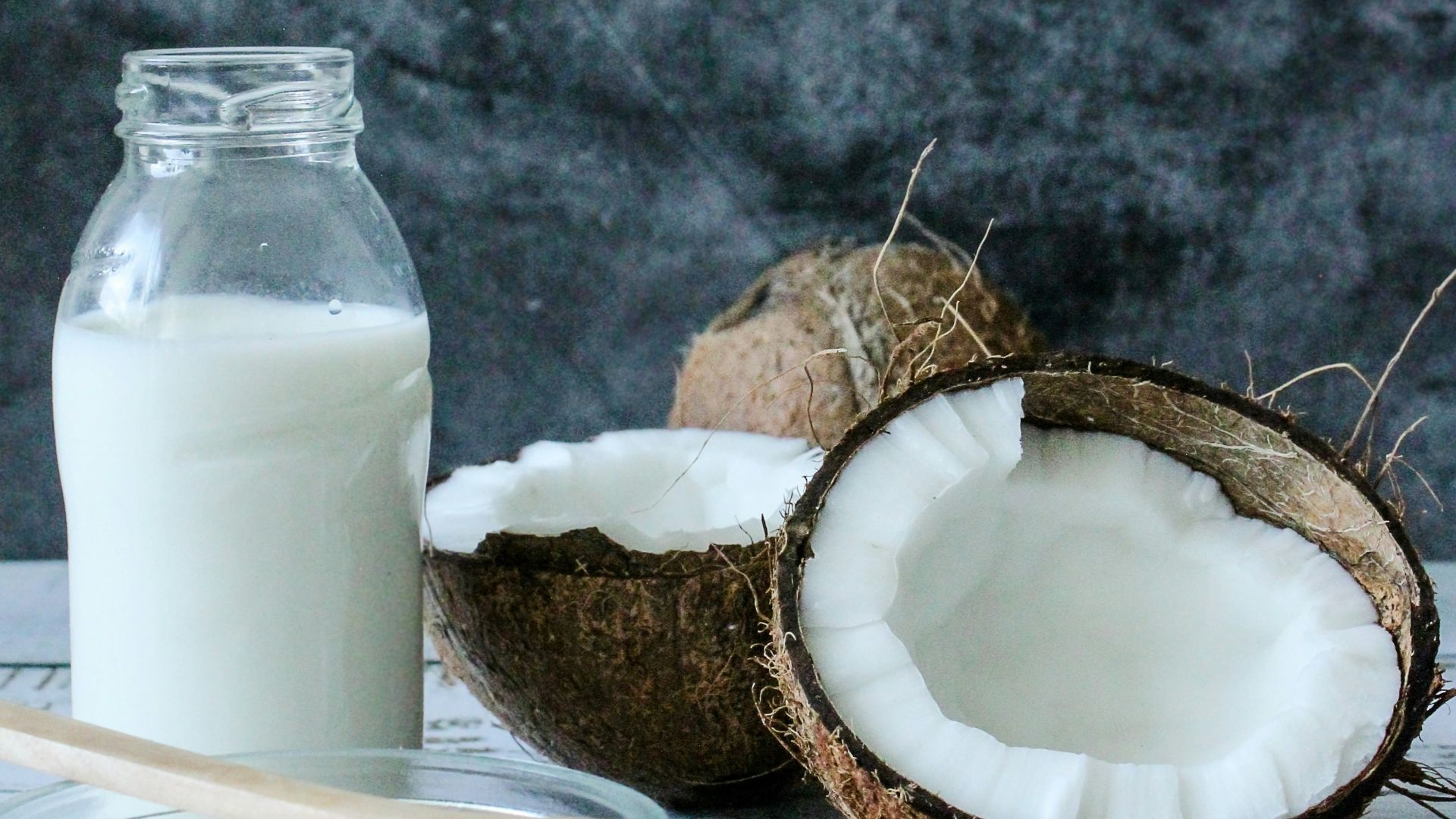 white pillar candle on brown wooden coaster