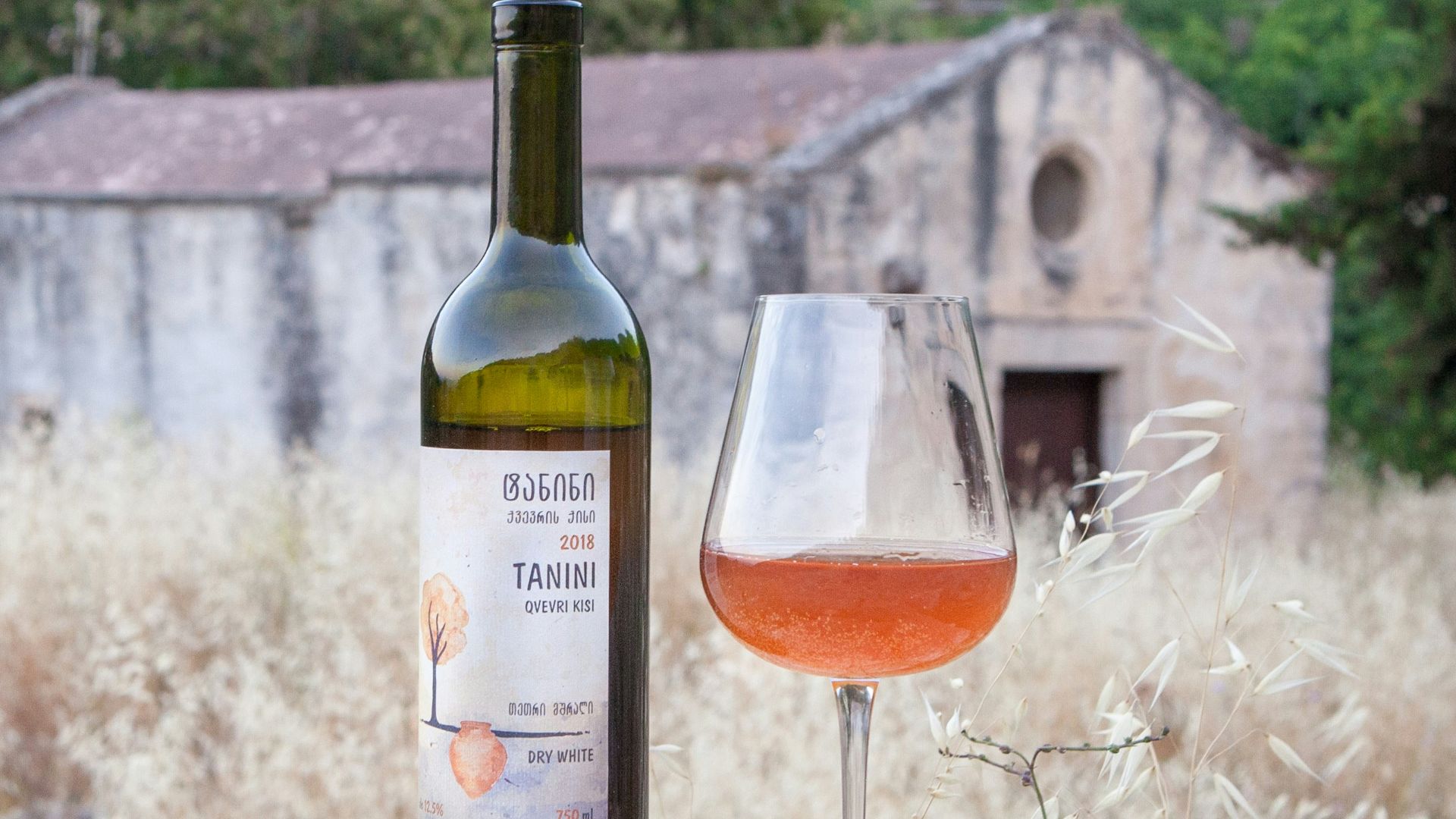 a bottle of wine sitting next to a glass of wine