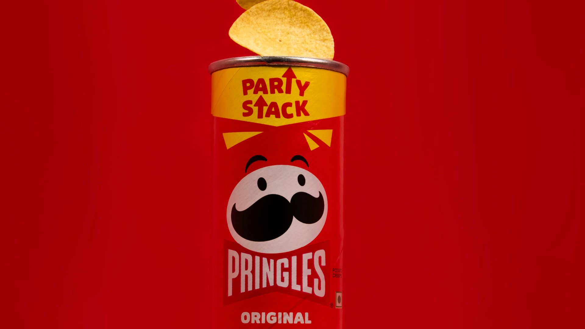 a can of pringles on a red background
