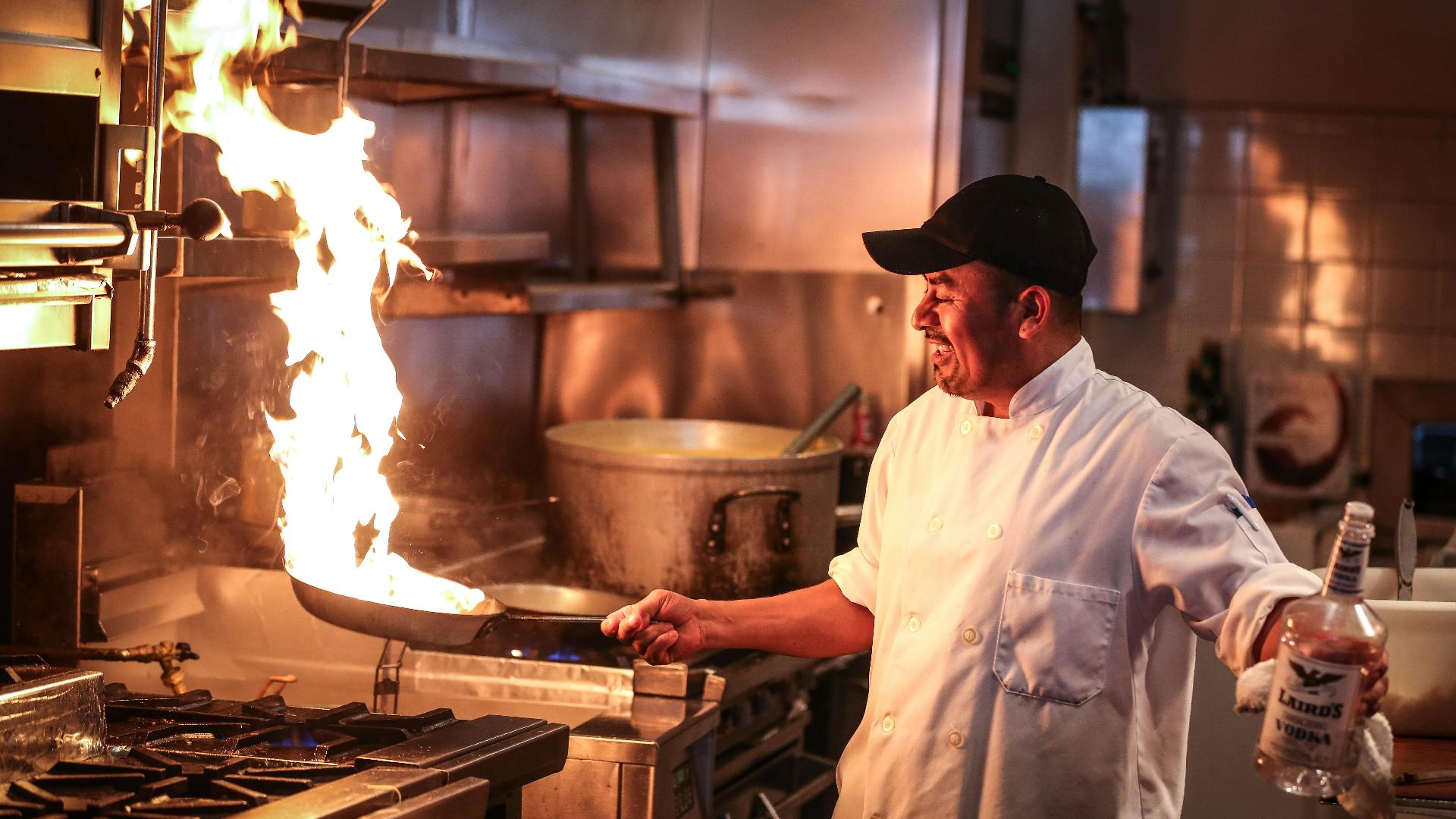 man in white chef uniform cooking