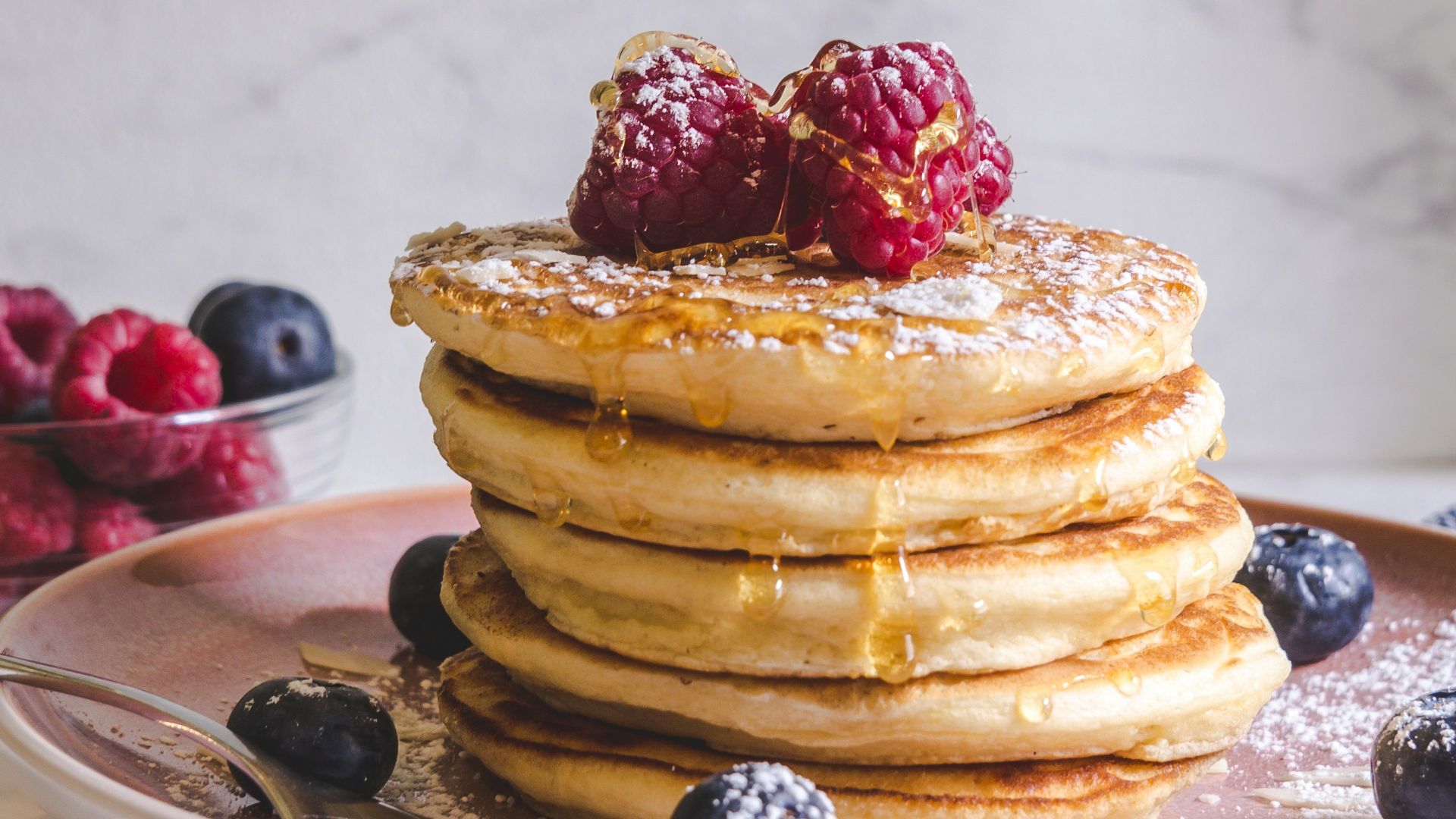 pancakes with berries on white ceramic plate