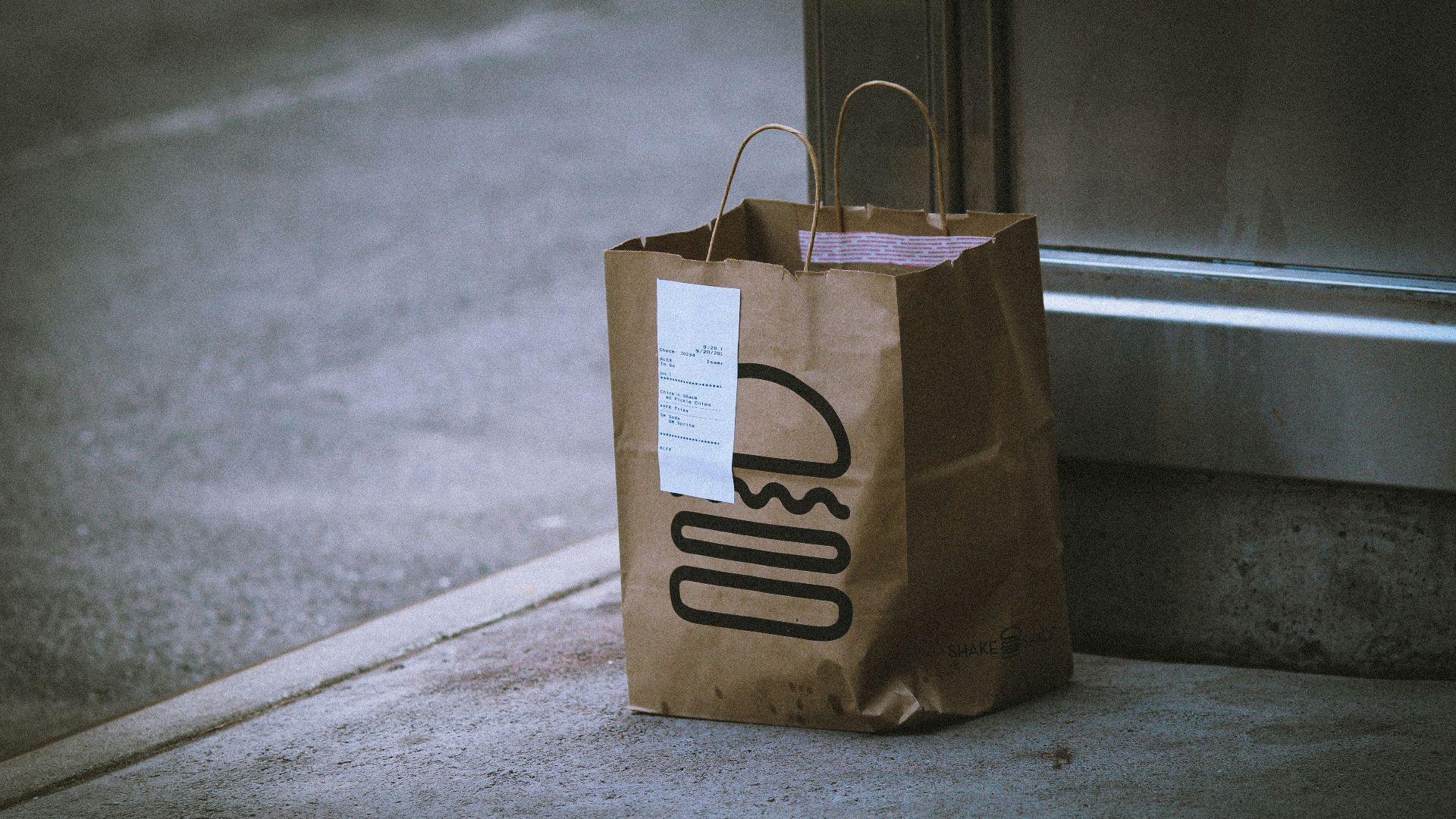 brown paper bag on gray concrete floor