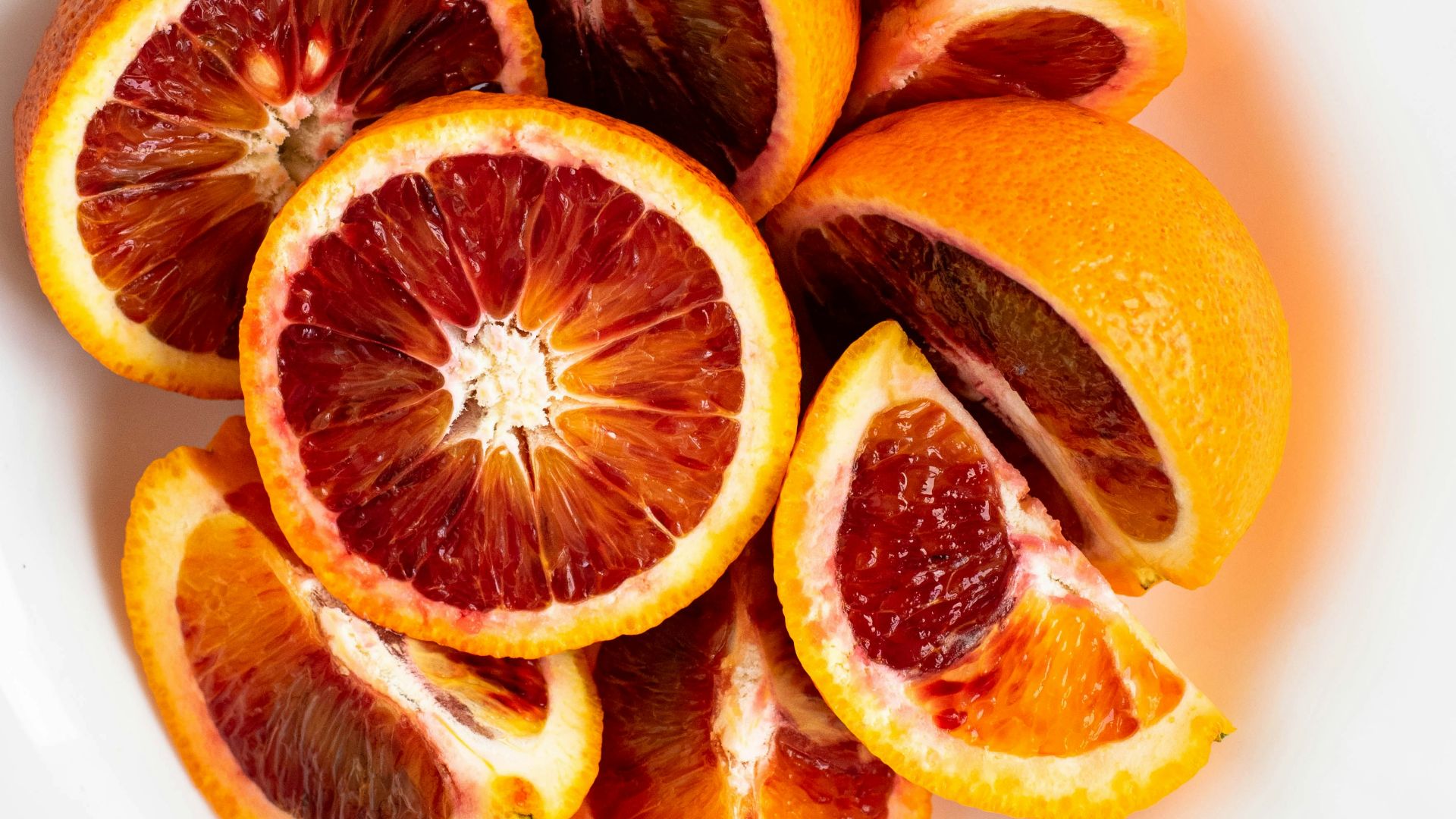 sliced orange fruit on white ceramic plate