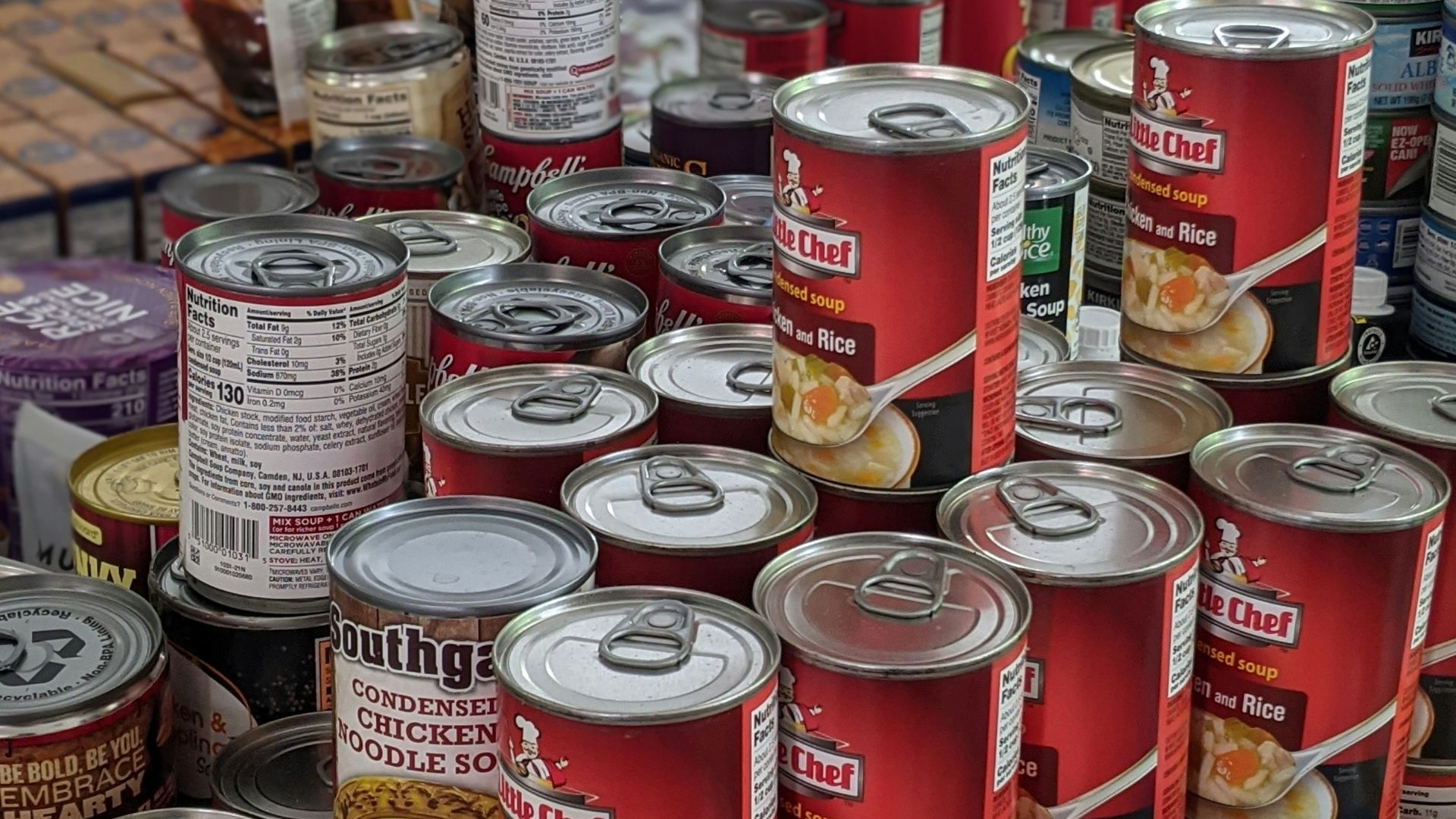 red and white labeled cans