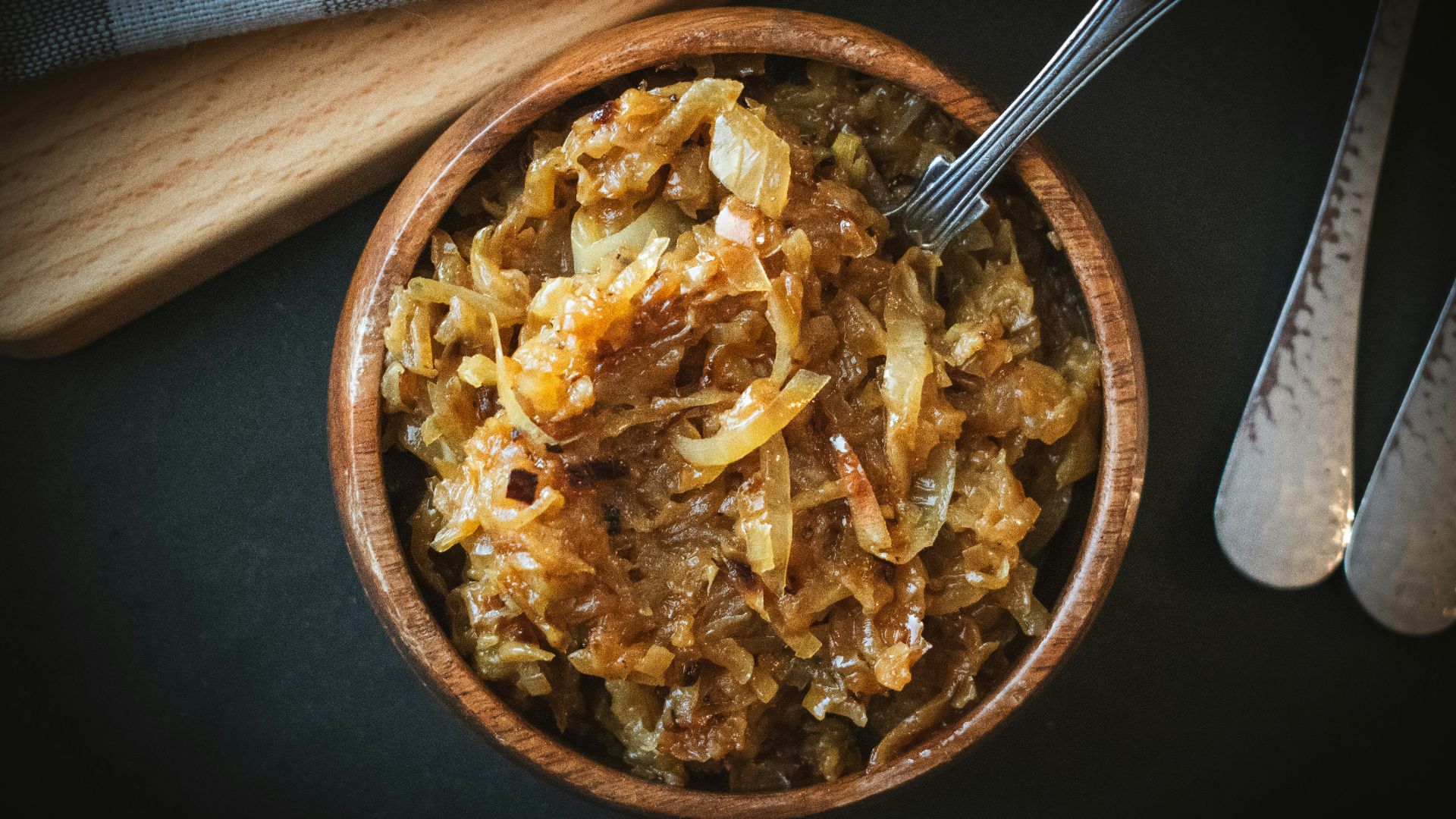 a bowl of food with a spoon next to it