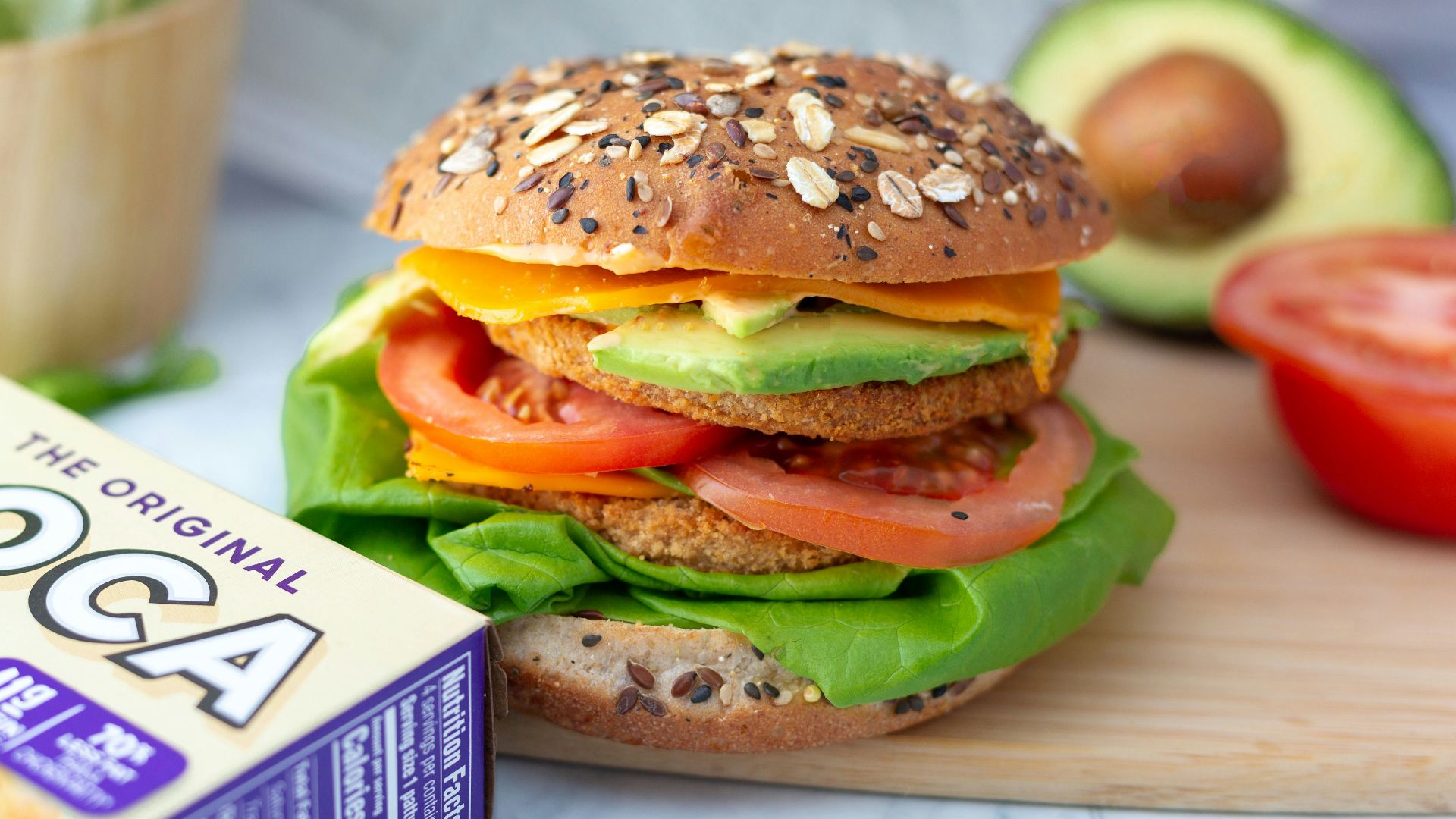 a hamburger sitting on top of a wooden cutting board