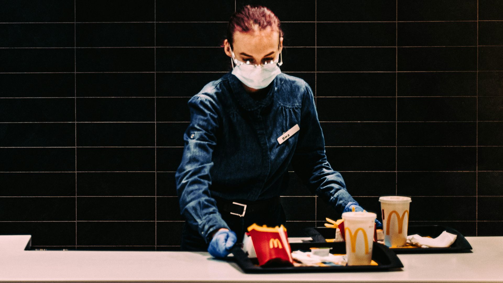 boy in black jacket sitting on white table