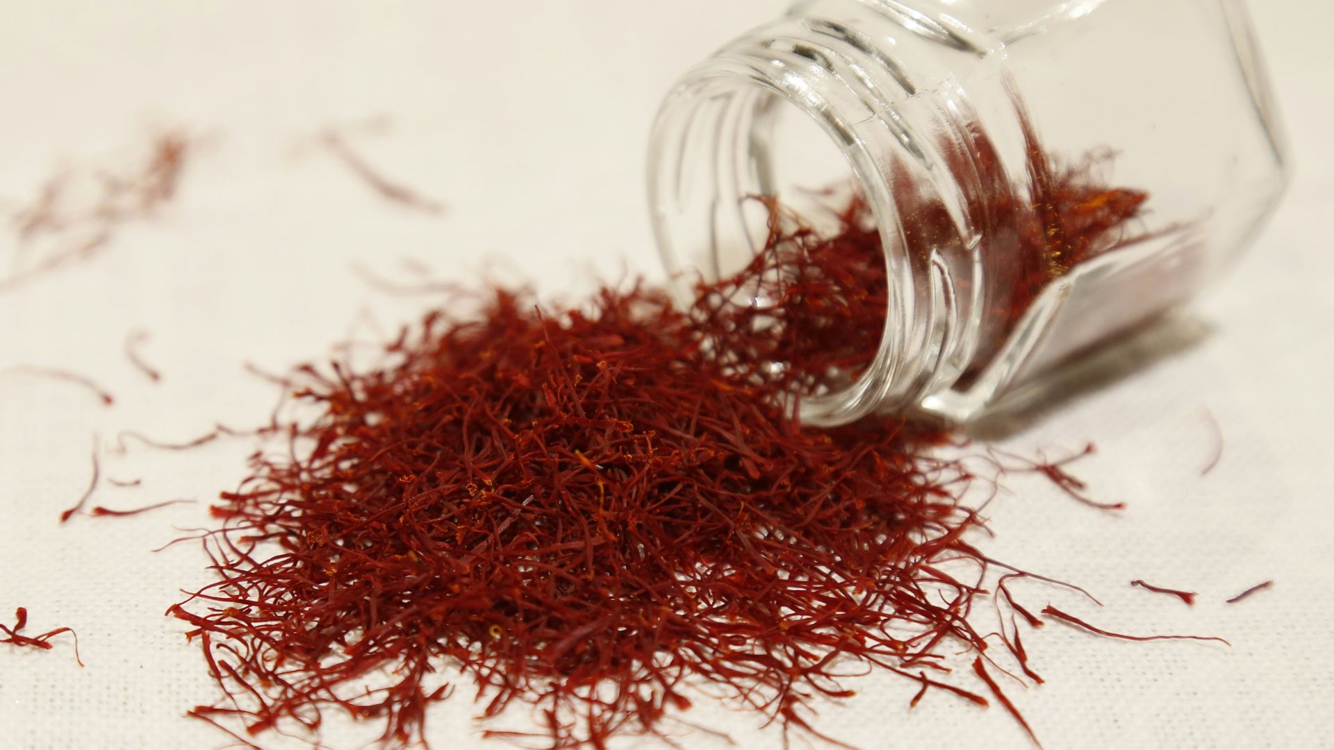 a glass jar filled with red stuff on top of a table