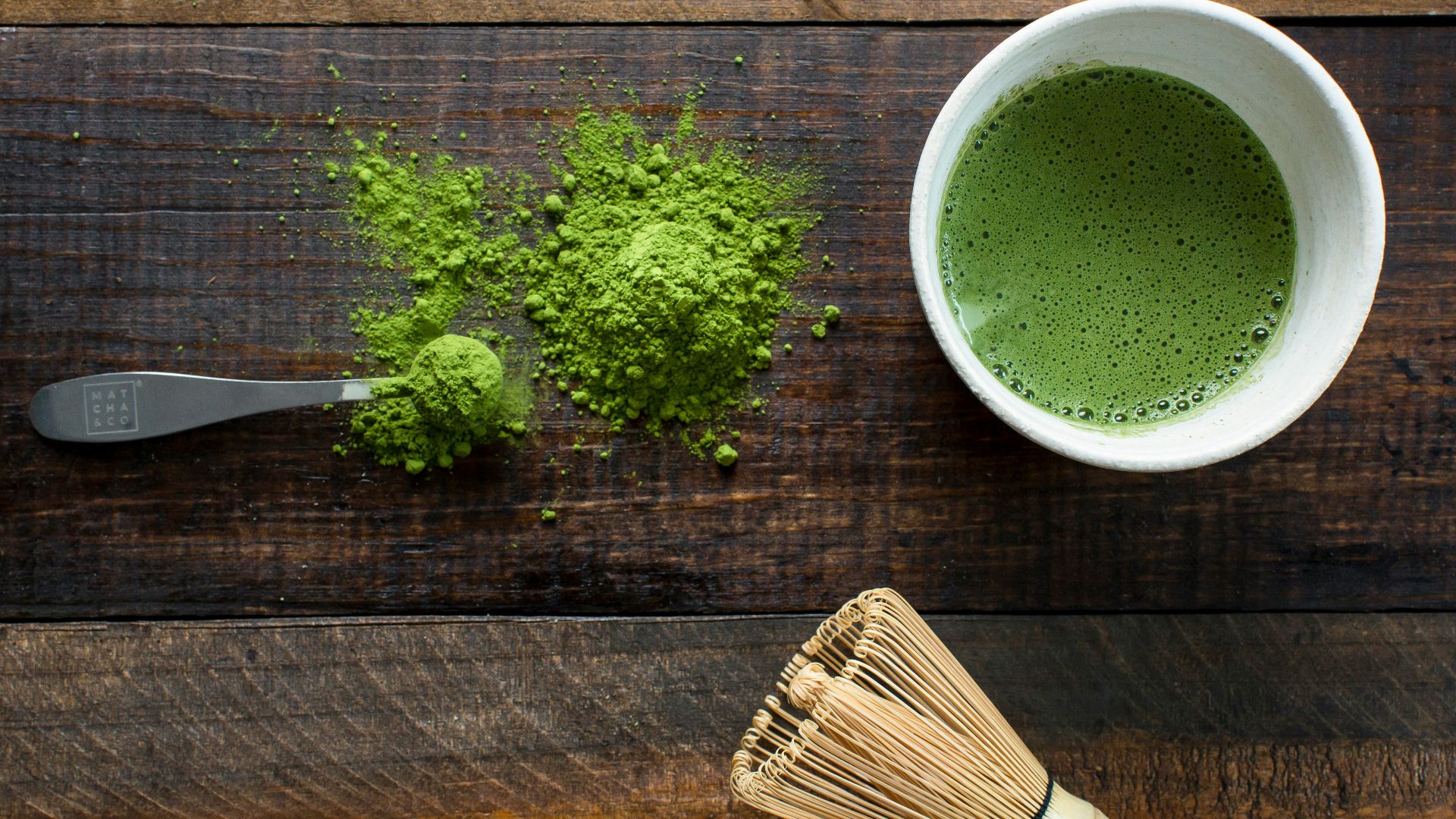 green plant in white ceramic mug beside brown wooden brush