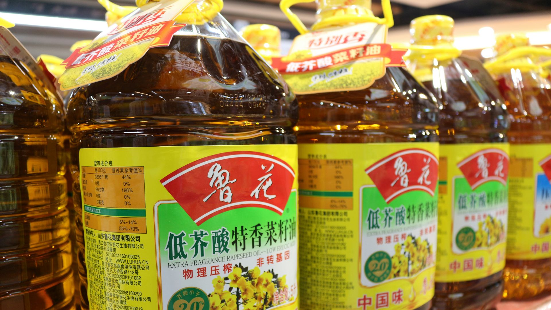 a row of bottles of honey sit on a shelf