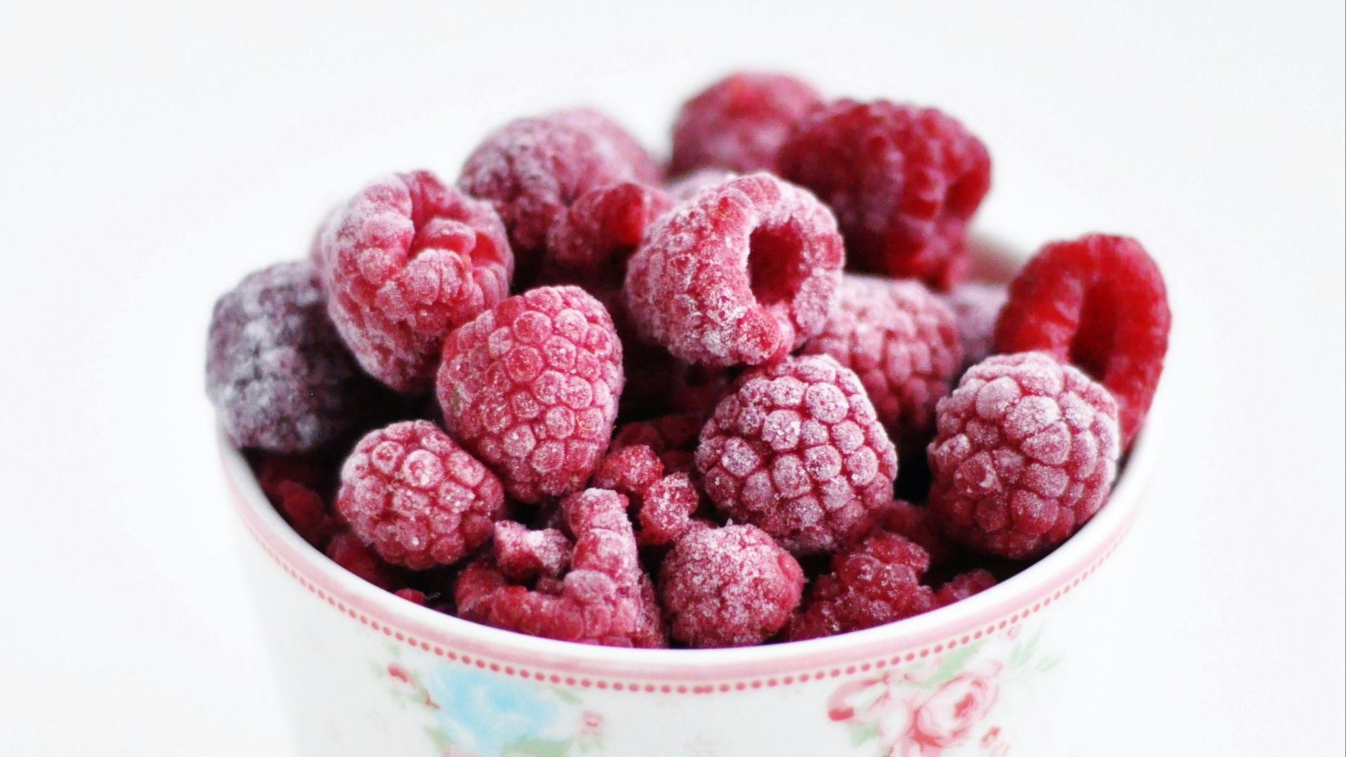 raspberry on white and pink floral ceramic cup