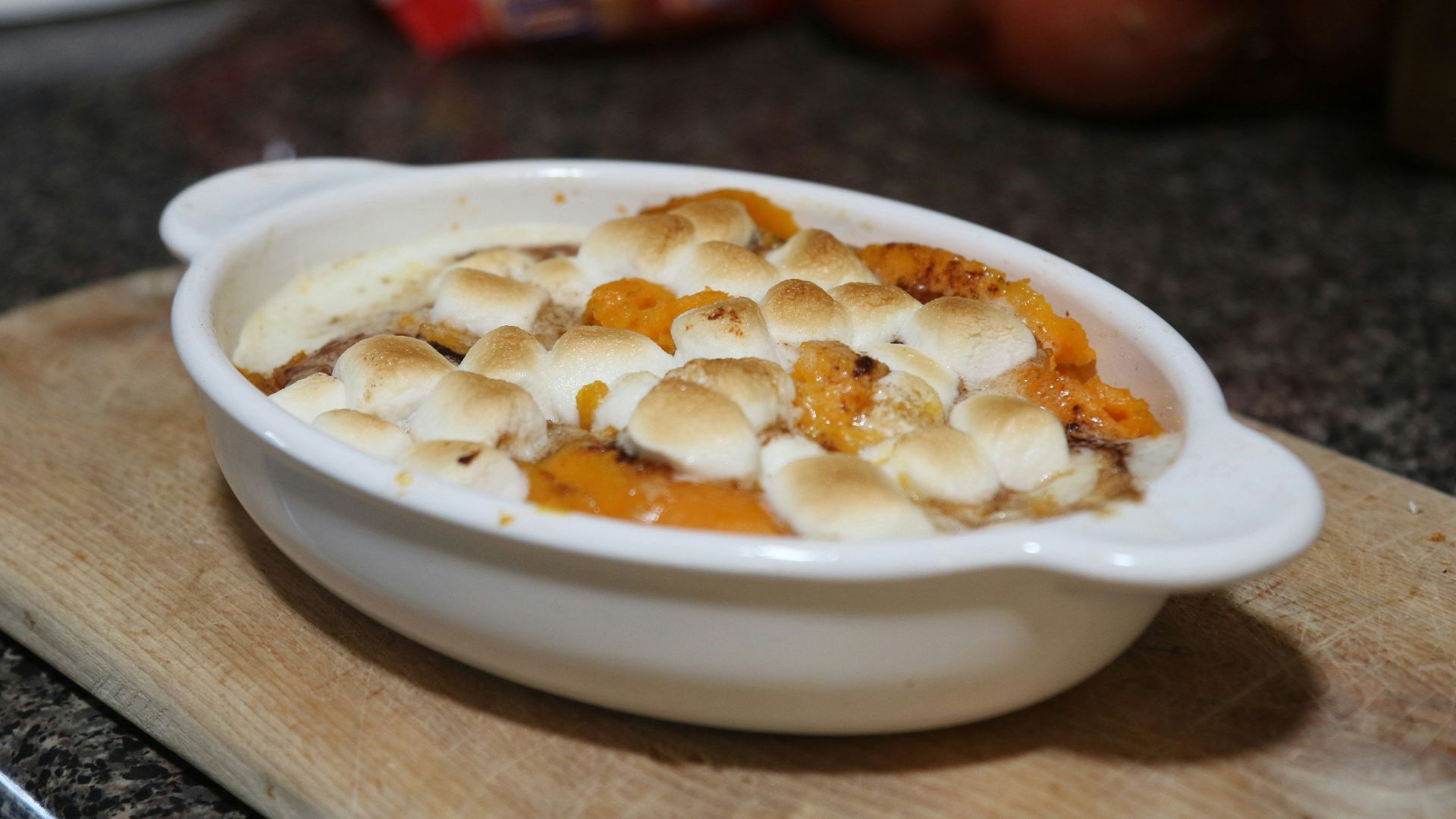 a bowl of food on a cutting board
