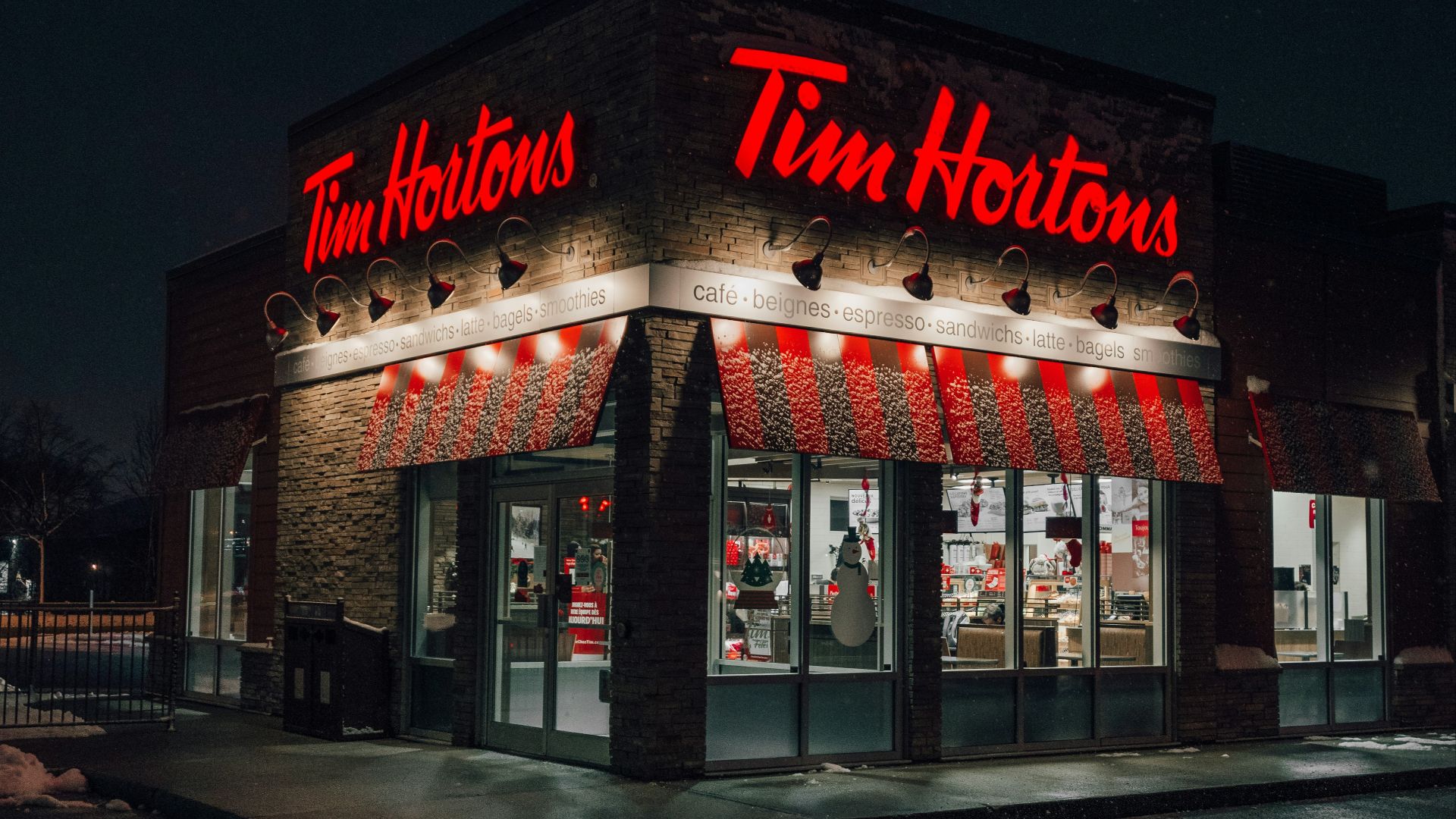 a tim hortons store lit up at night
