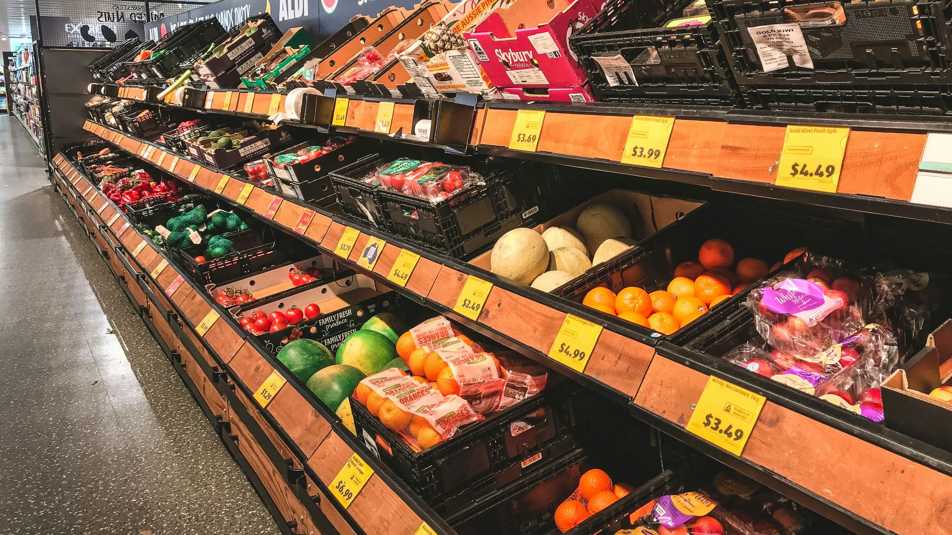 assorted fruits on brown wooden shelf