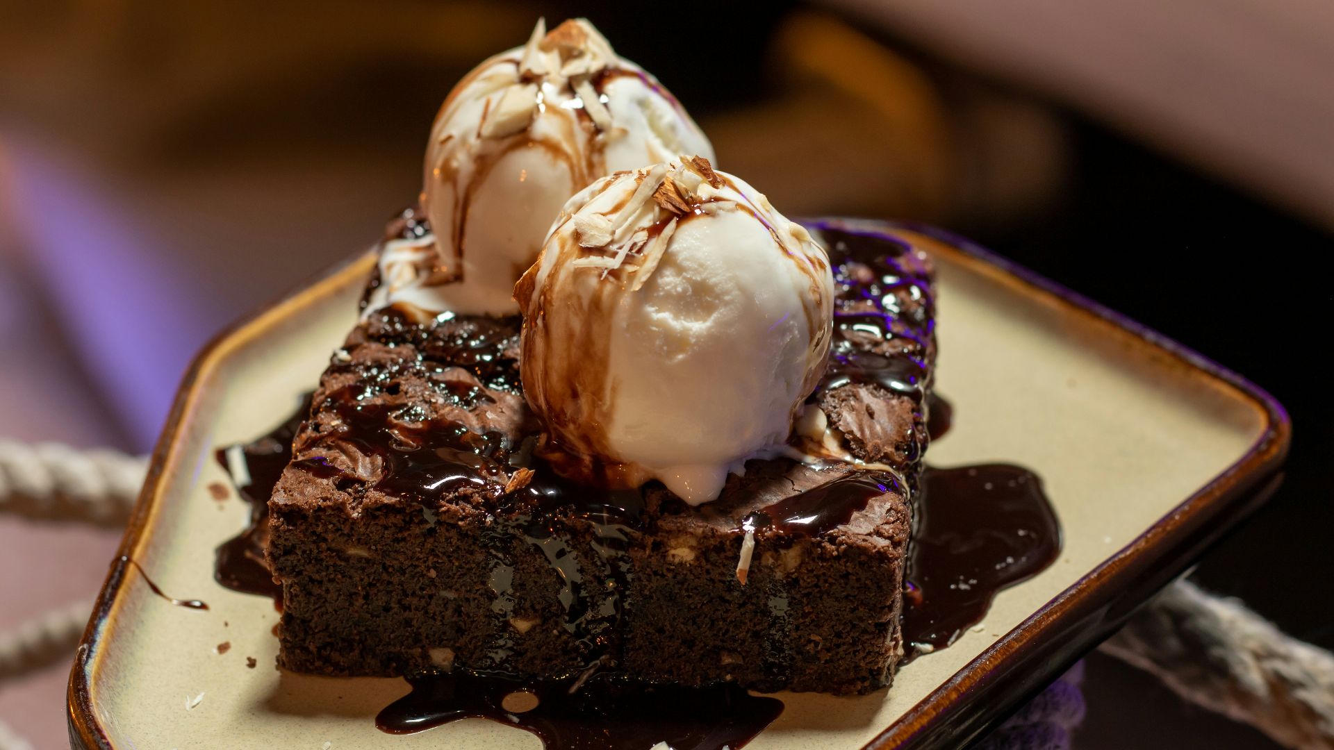 chocolate cake with white icing on white ceramic plate