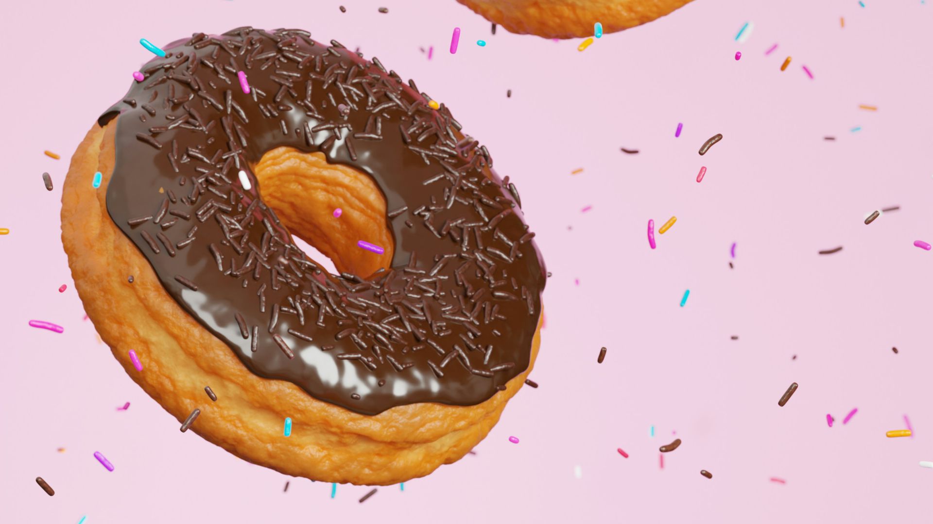 three donuts with pink frosting and sprinkles on a pink background