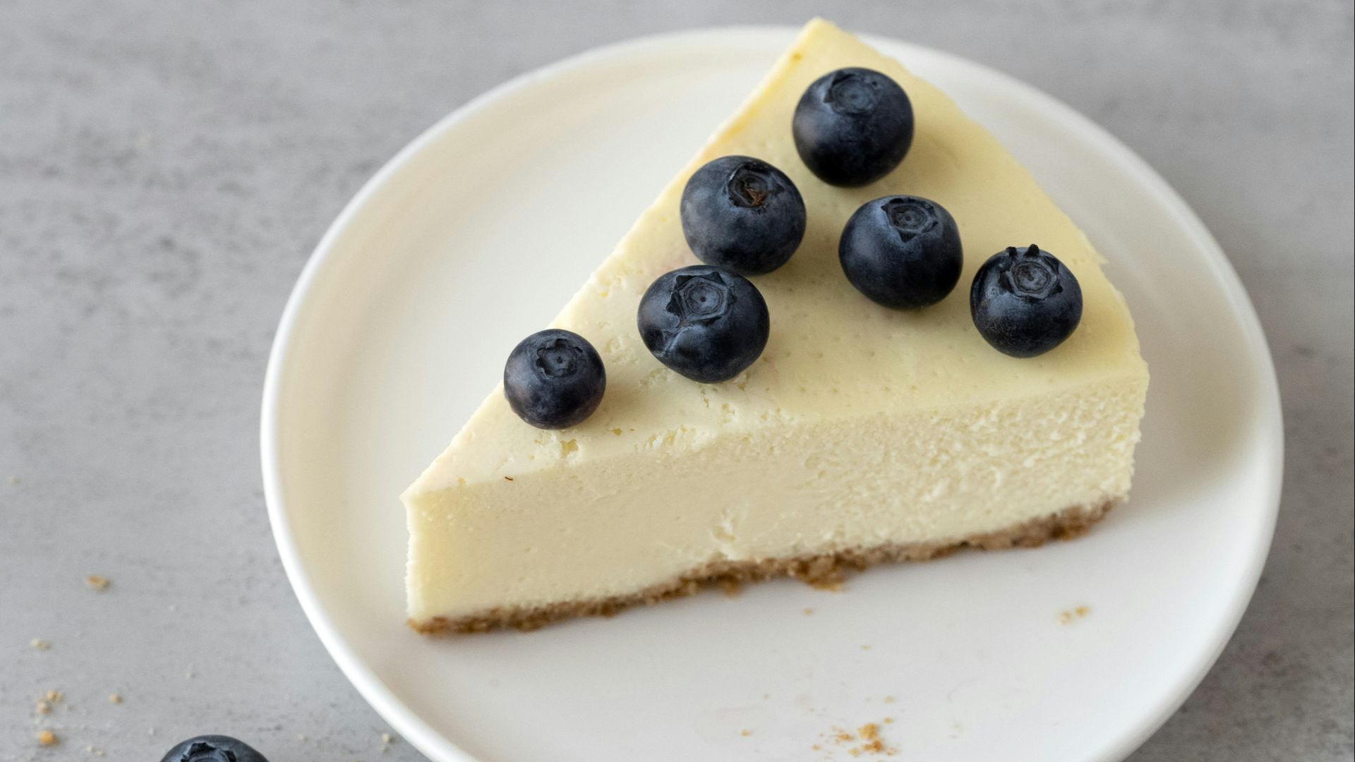 a slice of cheesecake with blueberries on a plate