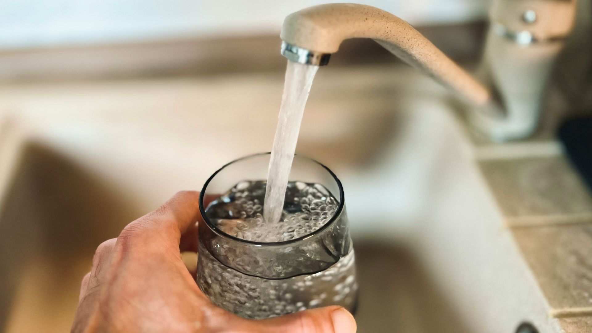 a hand holding a glass of water