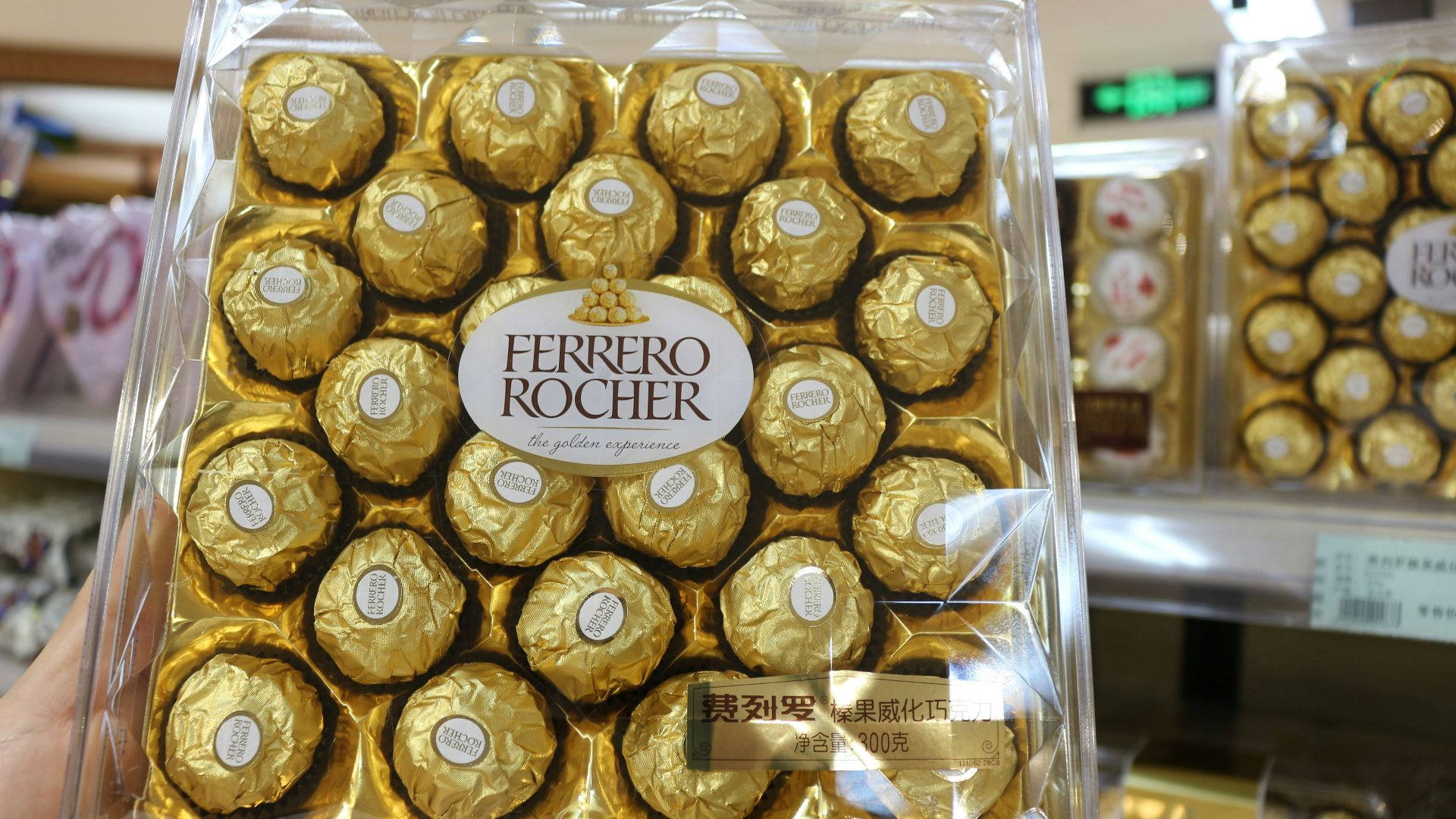 a person holding a box of chocolates in a store