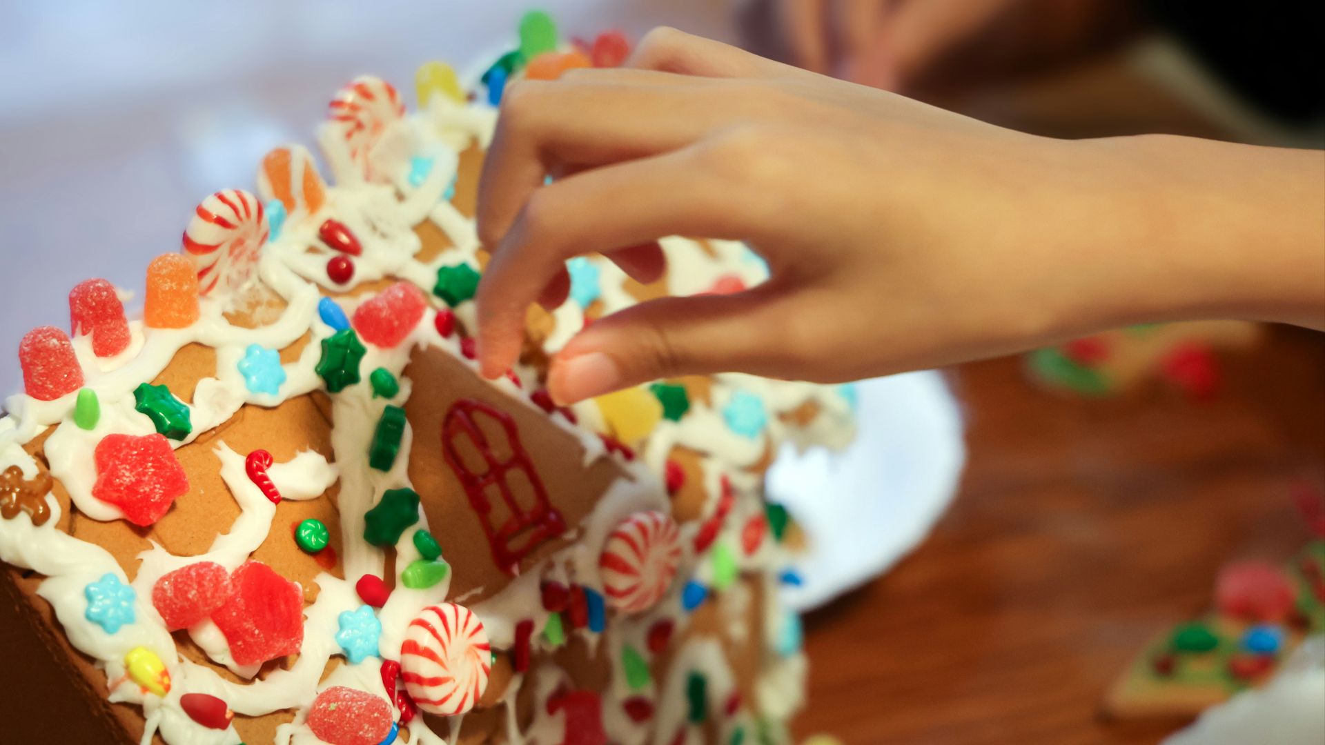person holding white and brown chocolate cake