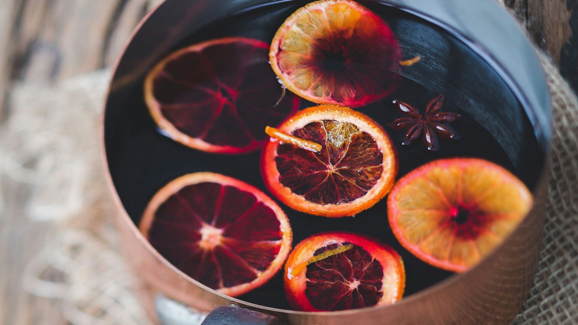 close-up photography of sliced orange fruit on brown cooking pot